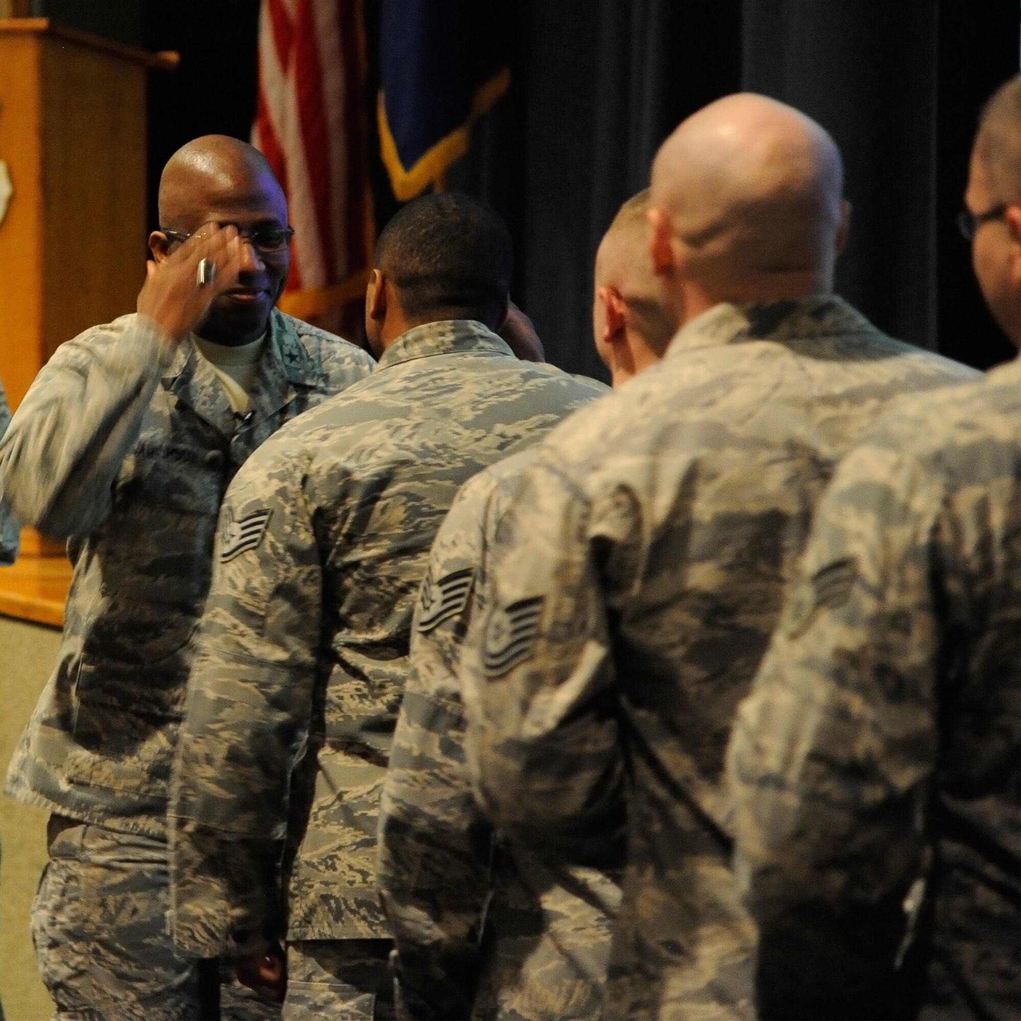 Brig. Gen. Allen Jamerson, director of security forces (left), salutes an Airman for a job well done during an all call at the base auditorium Feb 10. After the all call, Jamerson took time to speak with fellow security forces members and answer their questions on a one-on-one basis. (U.S. Air Force photo/Airman 1st Class Collin Schmidt)
