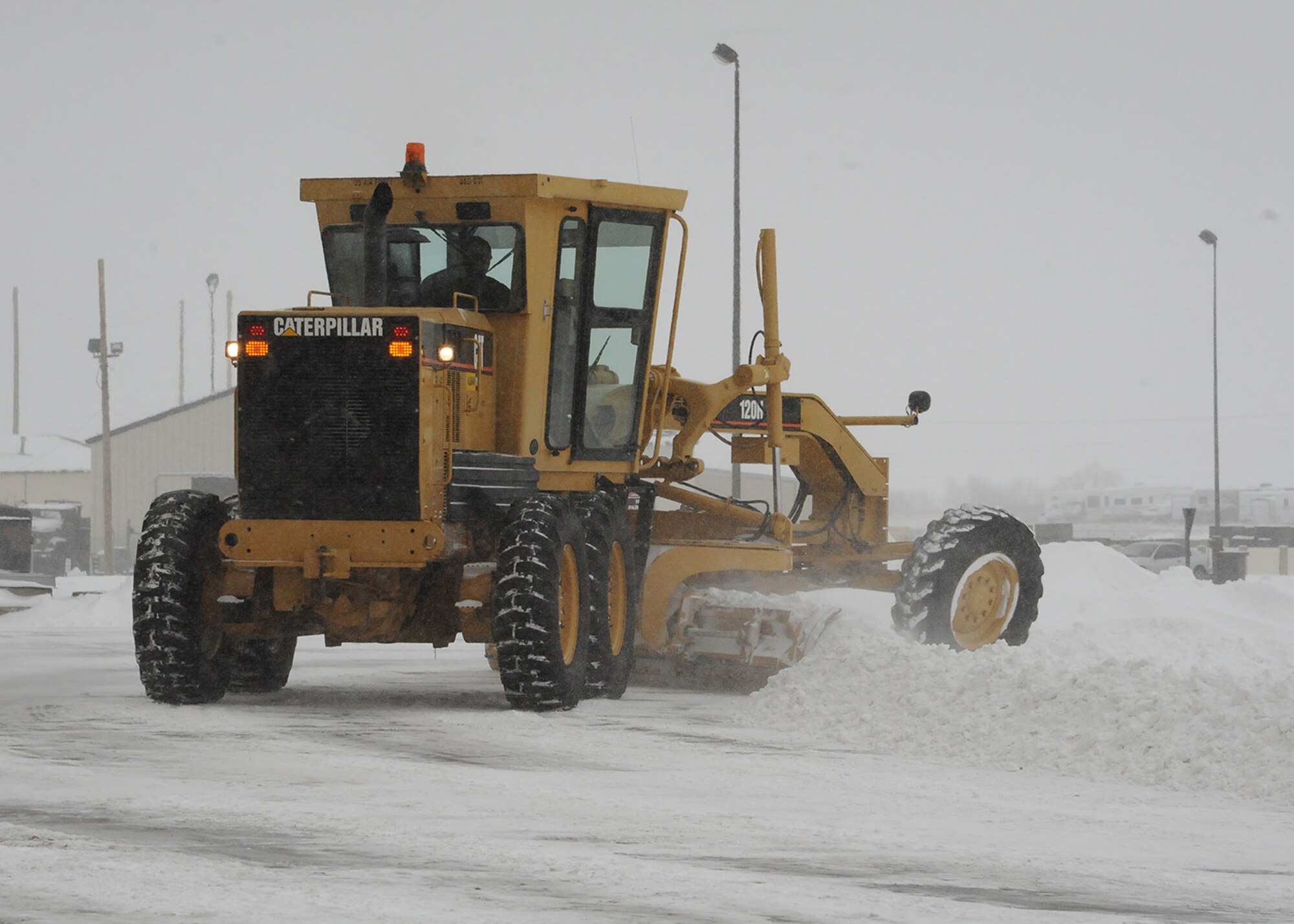 A member of Malmstrom’s 341st Civil Engineer Squadron snow removal team plows a parking lot after receiving several inches of snow in the days prior to Feb. 3. Vehicles as well as the Airmen at Malmstrom Air Force Base must be ready to perform in any type of weather, including the harsh, bitter 40-degree-below-zero weather conditions that were presented Feb. 5.. (U.S. Air Force photo/Senior Airman Cortney Paxton)