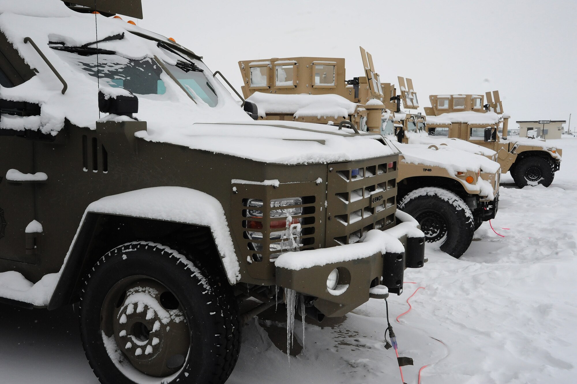 A security forces Bearcat and several Humvees sit outside Malmstrom’s 741st Missile Security Forces Squadron Tactical Response Force building with their block heaters plugged in. Vehicles, as well as the Airmen on Malmstrom Air Force Base, must be ready to perform in any type of weather, including the harsh, bitter 40-degree-below-zero weather conditions that were presented Feb. 5. (U.S. Air Force photo/Senior Airman Cortney Paxton)