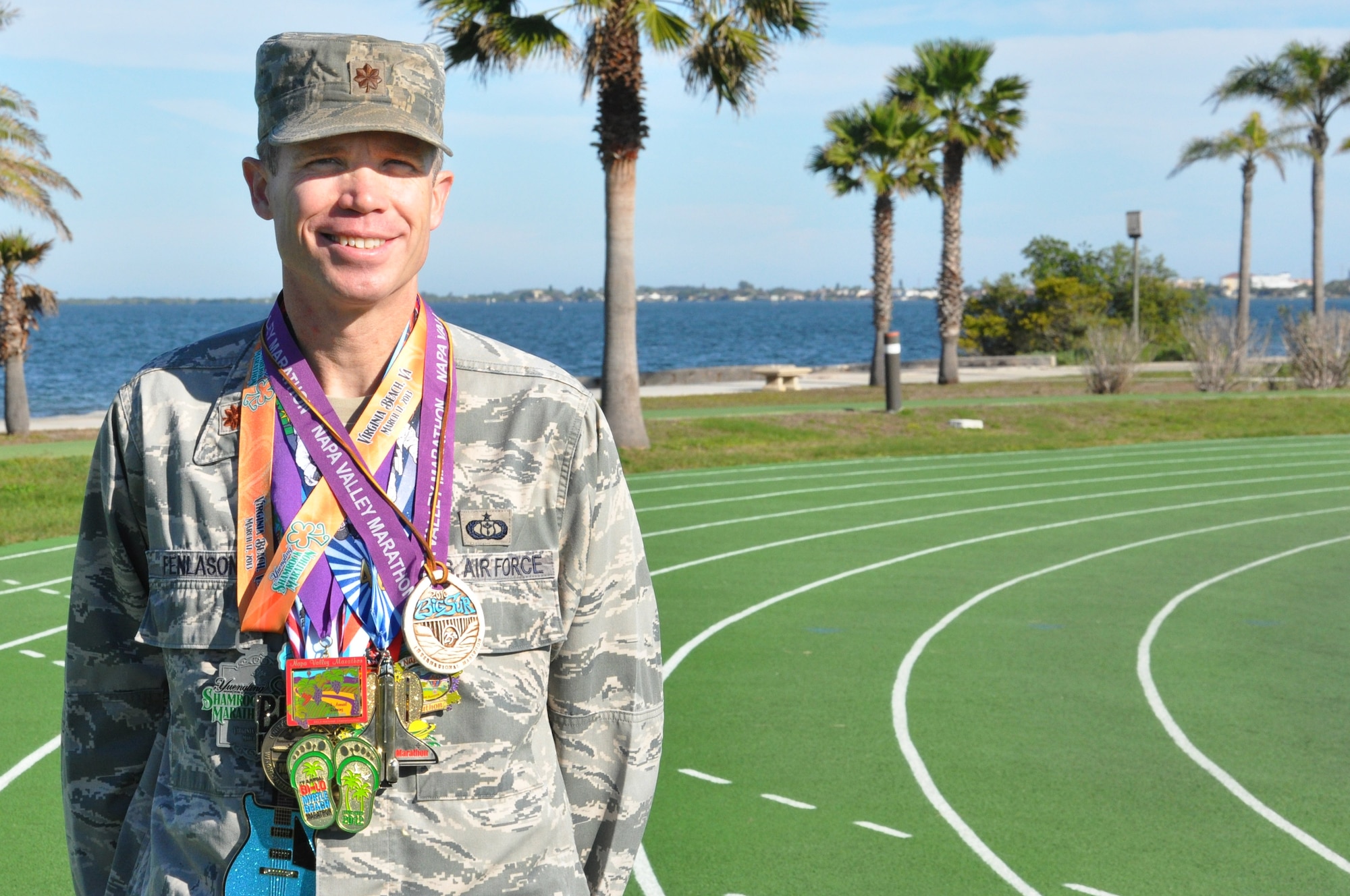 Maj. Joel Fenlason, 45th Space Wing deputy director of staff, displays some of the medals he has earned for running marathons over the past 9 years. He started running marathons in 2005 when he was 31 years old. His goal was to complete 50 marathons by his 40th birthday. Now 40, he is preparing to run his 75th marathon Feb. 16. (U.S. Air Force Photo/Tech. Sgt. Erin Smith)