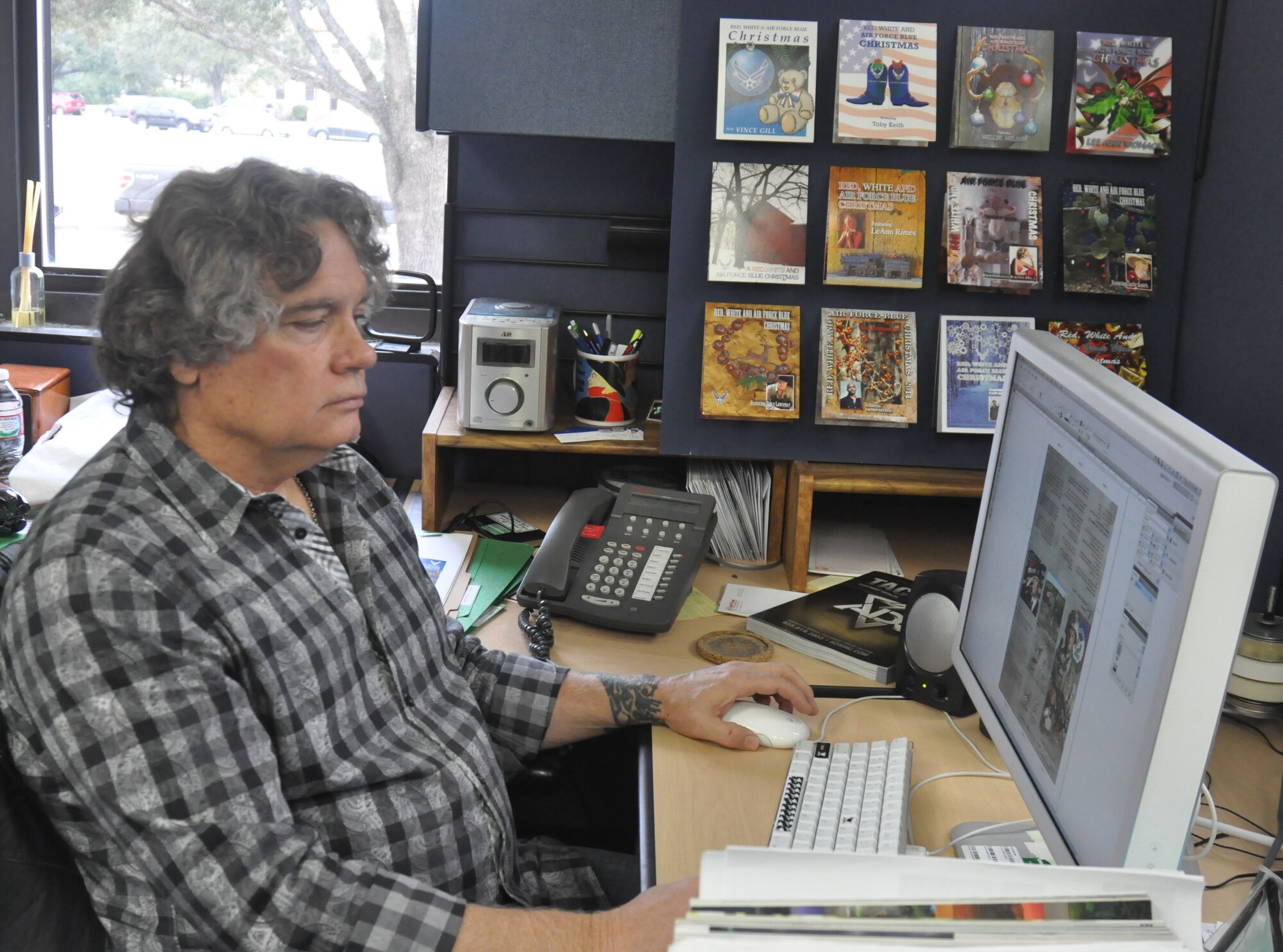Ronn Linn, Air Force Recruiting Service art director, is the creative force behind eight of the 12 “Red, White, and Air Force Blue Christmas” special CD covers. He has also designed many posters, all types of recruiting literature and even billboards.  (U.S. Air Force photo/Tech. Sgt. Hillary Stonemetz)