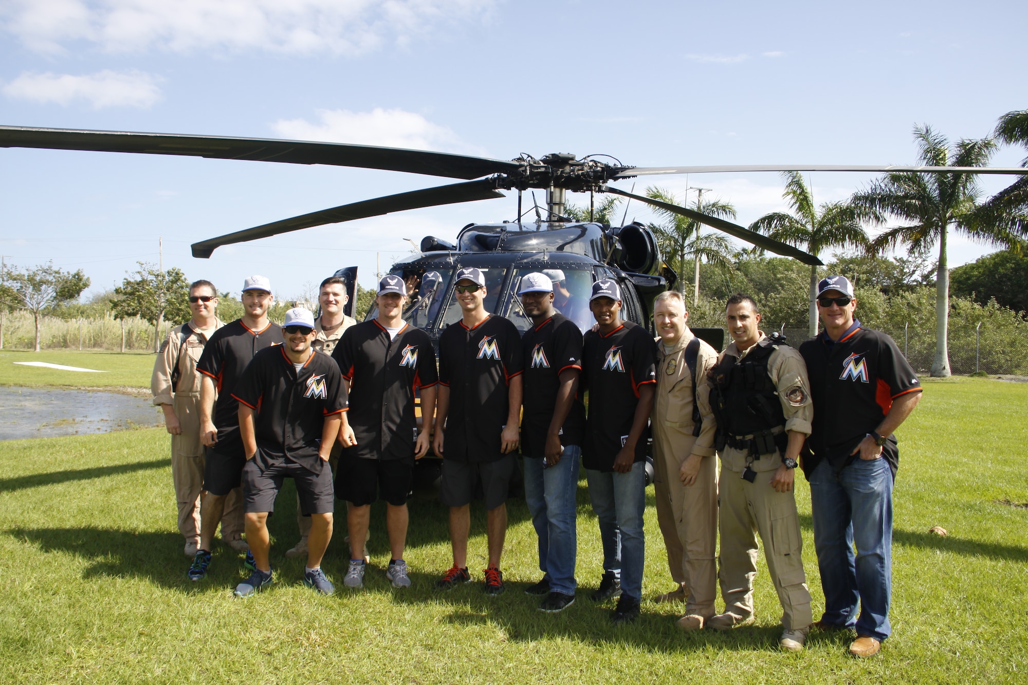 The Miami Marlin’s baseball team poses for a photo with members from the U.S. Customs and Border Protection in front of the UH-60 Blackhawk helicopter during the Team Homestead Appreciation Day at Homestead ARB Feb. 13. (U.S. Air Force photo by/Senior Airman Jaimi L. Upthegrove)