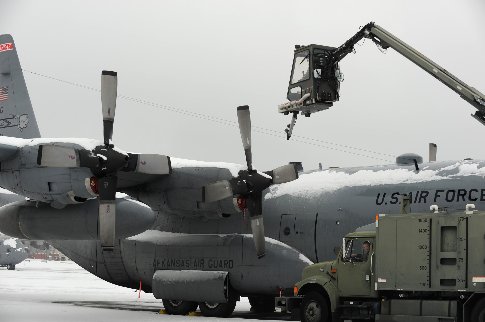 Airmen from the 189th Airlift Wing de-ice C-130s on the flightline Feb. 8, 2014, at Little Rock Air Force Base, Ark. Ice can temporarily halt the mission, creating a potentially negative impact on the mission Team Little Rock supports. Because of the importance of the mobility mission to the Air Force, it is essential for Airmen to have de-icers ready to work at a moment’s notice to keep the mission on track and aircraft in the air during winter. (U.S. Air Force photo by Airman 1st Class Scott Poe) 