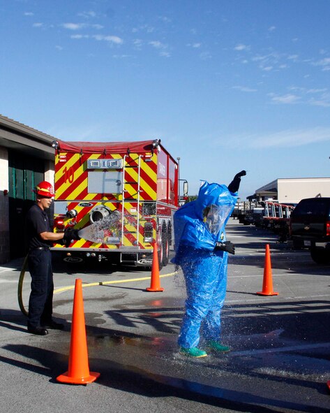 A member of the 482nd Civil Engineering Squadron Emergency Management flight, at Homestead Air Reserve Base, Fla., is sprayed down with water from the Homestead ARB Fire Department during an emergency decontamination during their annual hazardous material exercise at Homestead ARB, Feb. 8. (U.S. Air Force photo by/Senior Airman Jaimi L. Upthegrove)