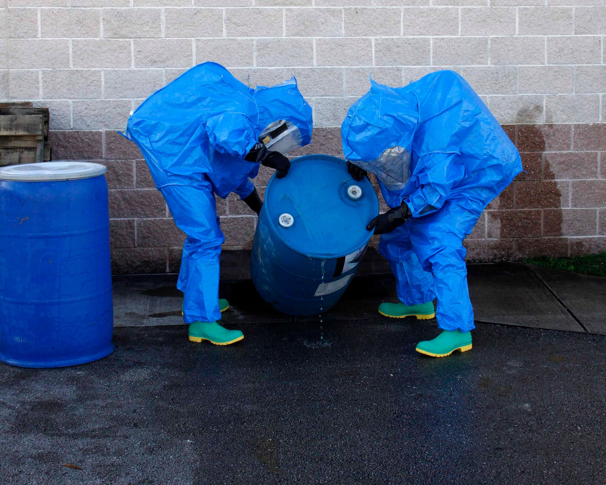 Senior Airman Juan Rodriguez and Senior Airman Anthony Ramirez, emergency management technicians with the 482nd Civil Engineering Squadron Emergency Management flight at Homestead Air Reserve Base, Fla., re-orient a second barrel to fix the hole at the bottom during their annual hazardous material exercise at Homestead ARB, Feb. 8. (U.S. Air Force photo by/Senior Airman Jaimi L. Upthegrove)