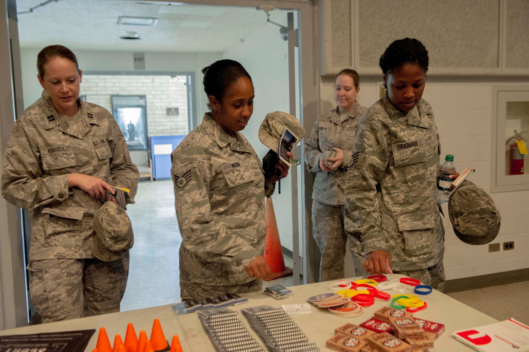 Frontline Supervisor Training attendees look through free swag before taking the three-hour course focused on suicide prevention and improving supervisory skills at the base theater on Joint Base Pearl Harbor-Hickam, Hawaii, Feb. 13. The interactive course provided in-depth training on assisting personnel in distress as well suicide prevention. (U.S. Air Force photo/Tech. Sgt. Terri Paden)