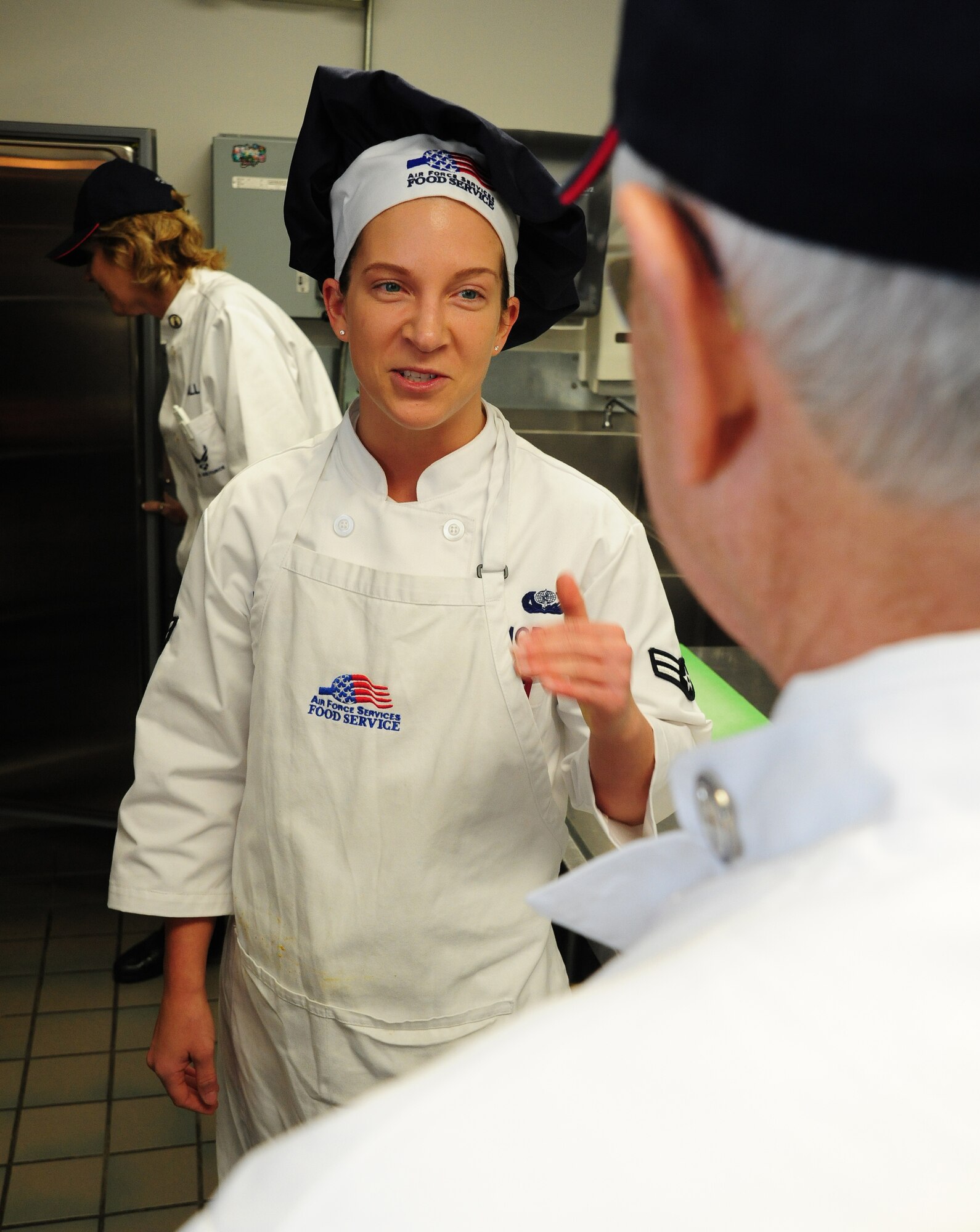 Airman 1st Class Elizabeth Morgan, 509th Force Support Squadron food services specialist, briefs Joe DeRossa, Hennessy Team evaluator, on food preparations at the Touch and Go flight kitchen at Whiteman Air Force Base, Mo., Feb. 5, 2013. Team Whiteman was judged on in-flight meals, the Ozark Inn dining facility and the Touch and Go flight kitchen on 48 different criteria in five separate categories. (U.S. Air Force photo by Staff Sgt. Nick Wilson/Released)