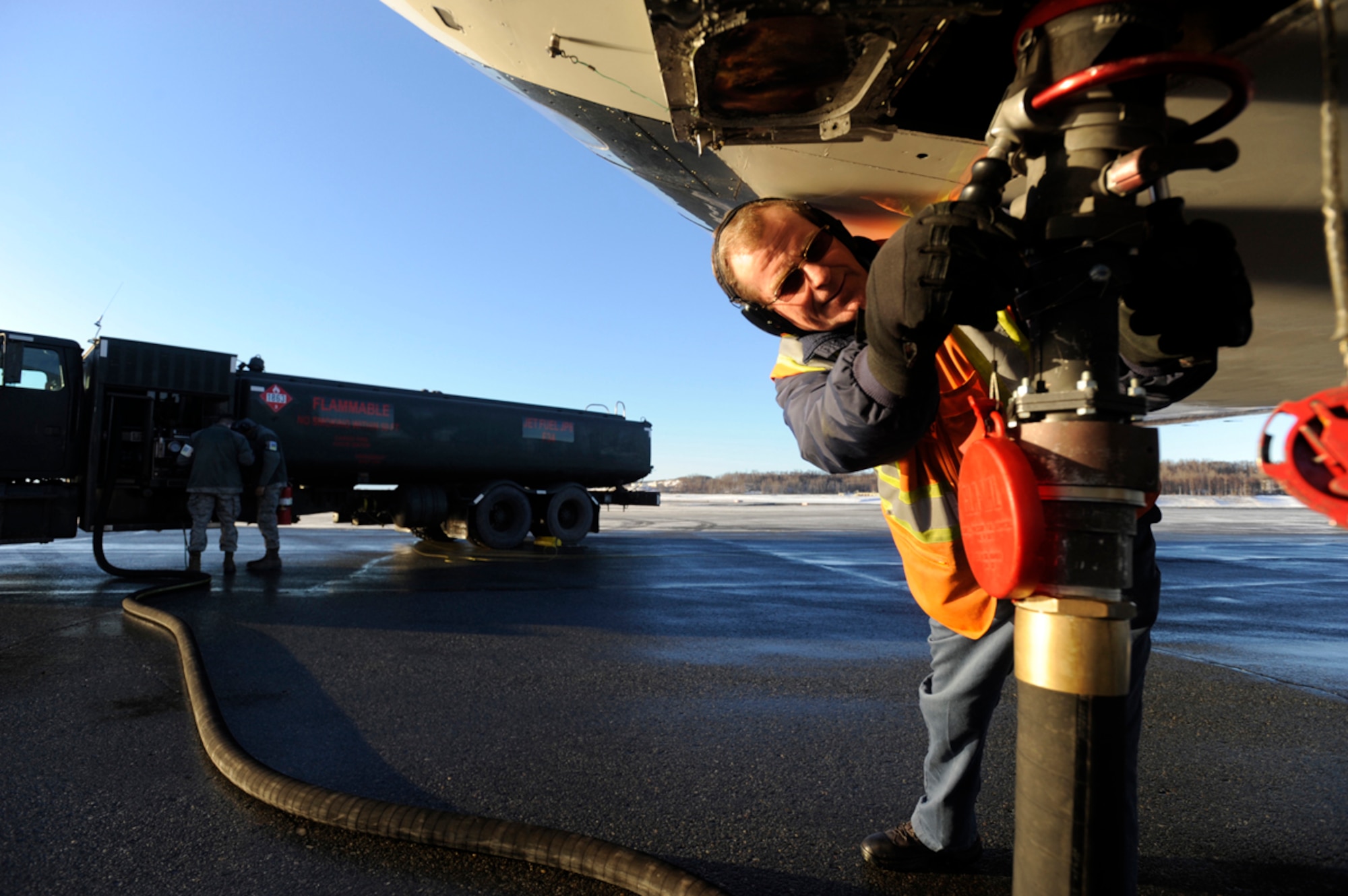 Gary Howard, 3rd Maintenance Squadron Transient Alert aircraft servicer, prepares an aircraft for refueling on the flight line at Joint Base Elmendorf-Richardson, Alaska, Jan. 29, 2014. TA supports the forward movement of missions to and from JBER. (U.S. Air Force photo/Staff Sgt. Robert Barnett)