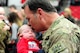 U.S. Army Sgt. 1st Class Ed Borgstadt, 1-135th Attack Reconnaissance Battalion operations NCO in charge, kisses his three-week-old grandson for the first time following the unit's welcome-home ceremony at the University of Central Missouri 
in Warrensburg, Mo., Feb. 9, 2014. Borgstadt returned home after a year-long deployment to Afghanistan in support of Operation Enduring Freedom. (U.S. Air Force photo by Staff Sgt. Nick Wilson/Released)