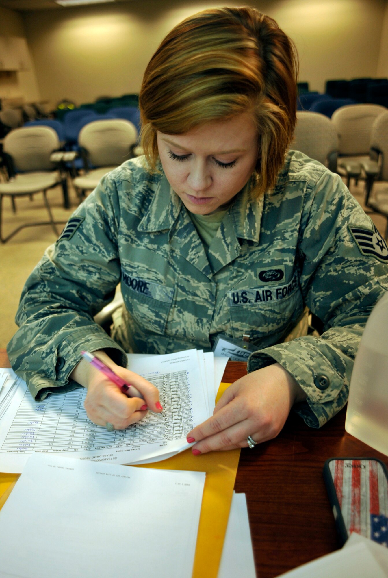 Air Force Staff Sgt. Jacquelyn Moore, 673d Force Support Squadron force management supervisor, checks accountability of military members within a deployment chalk at the Joint Mobility Center on Joint Base Elmendorf-Richardson during Exercise Polar Force 14-2, Feb. 11. Chalks are separate groups of Airmen sent to the JMC where they finalize preparations before going to deployed locations. A total of 25 chalks processed at the JMC with between five and 80 military members in each. (U.S. Air Force photo/Airman 1st Class Tammie Ramsouer)