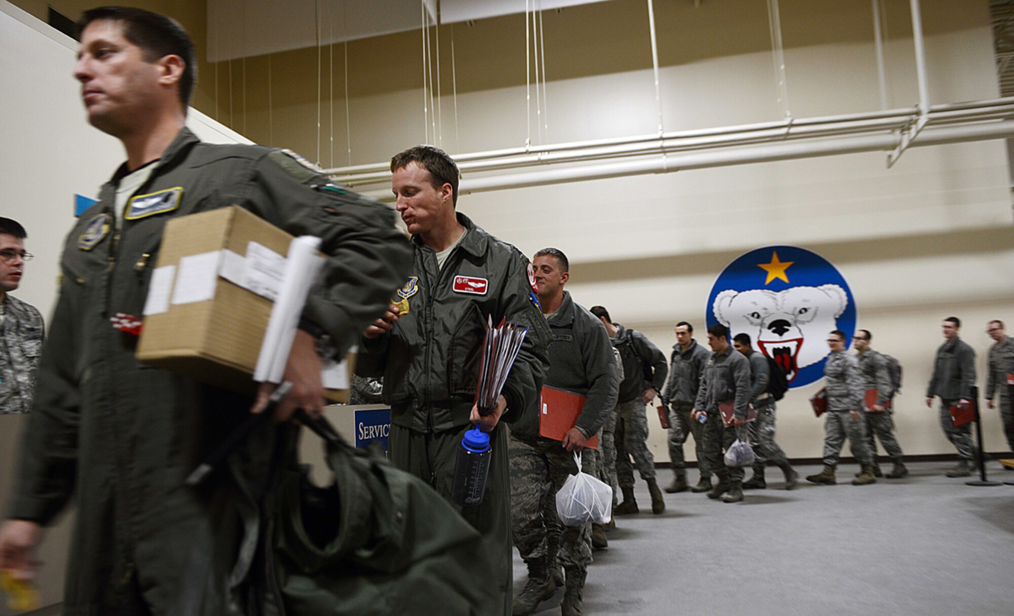 JOINT BASE ELMENDORF-RICHARDSON, Alaska -- Airmen proceed through the processing line during a mock deployment at the Joint Mobility Center Feb. 10. During the deployment, nine chalks of Airmen were processed to various areas of engagement. Chalks are seperate groups of Airmen sent to the JMC where they are briefed, fed and have the opportunity to finalize all paperwork before going to their respective deployed locations. (U.S. Air Force photo/Airman 1st Class Ty-Rico Lea)