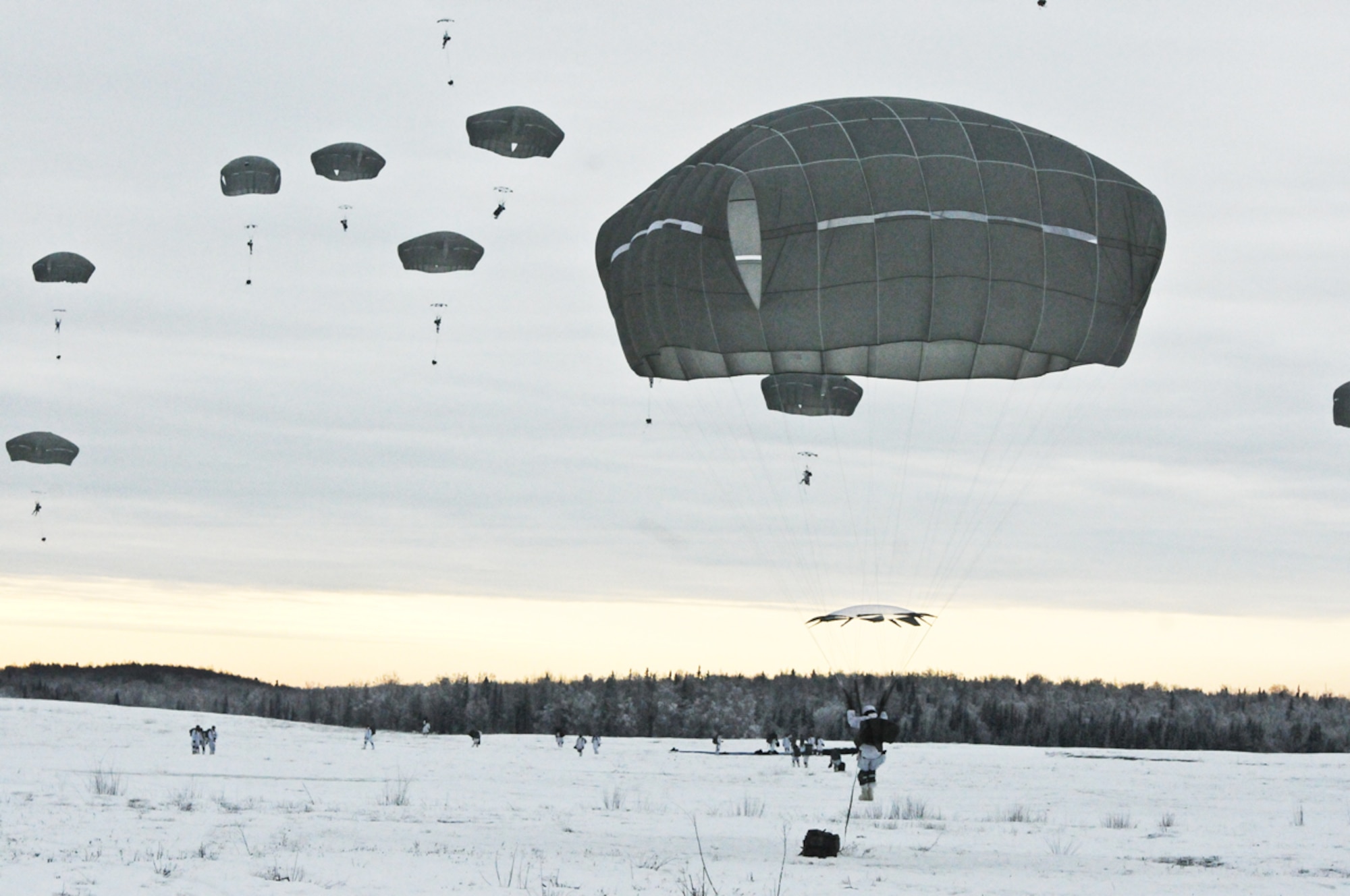Paratroopers of the 4-25th IBCT jump from a U.S. Air Force C-17 Globemaster III aircraft as part of a combined air drop, called a friendship jump, during the joint Thai-U.S. training exercise on Malemute Drop Zone at JBER Feb. 6. The Spartan Brigade is preparing for their upcoming role in Exercise Cobra Gold 2014 in the Kingdom of Thailand.   (U.S. Army photo/Staff Sgt. Jeffrey Smith)

