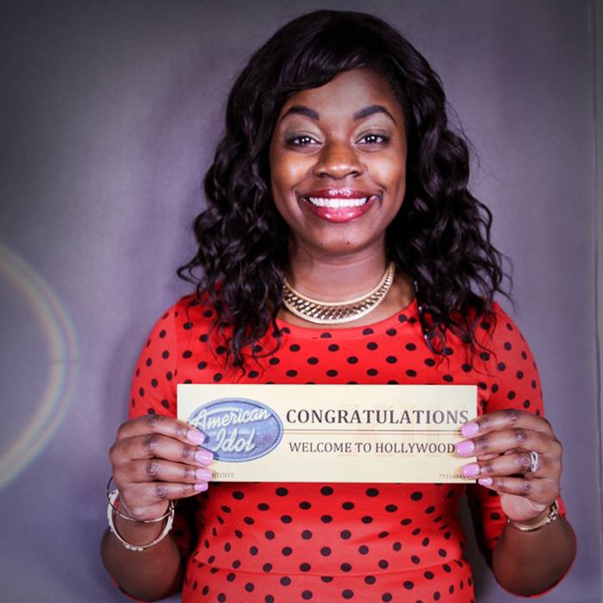 U.S. Air Force Senior Airman Paula Hunt, a vocalist with the U.S. Air Force Heartland of America Band at Offutt Air Force Base, Neb., holds up the golden ticket she received Oct. 14 in Omaha, Neb. that advances her to the final audition of American Idol’s Hollywood Week. (Courtesy Photo)
