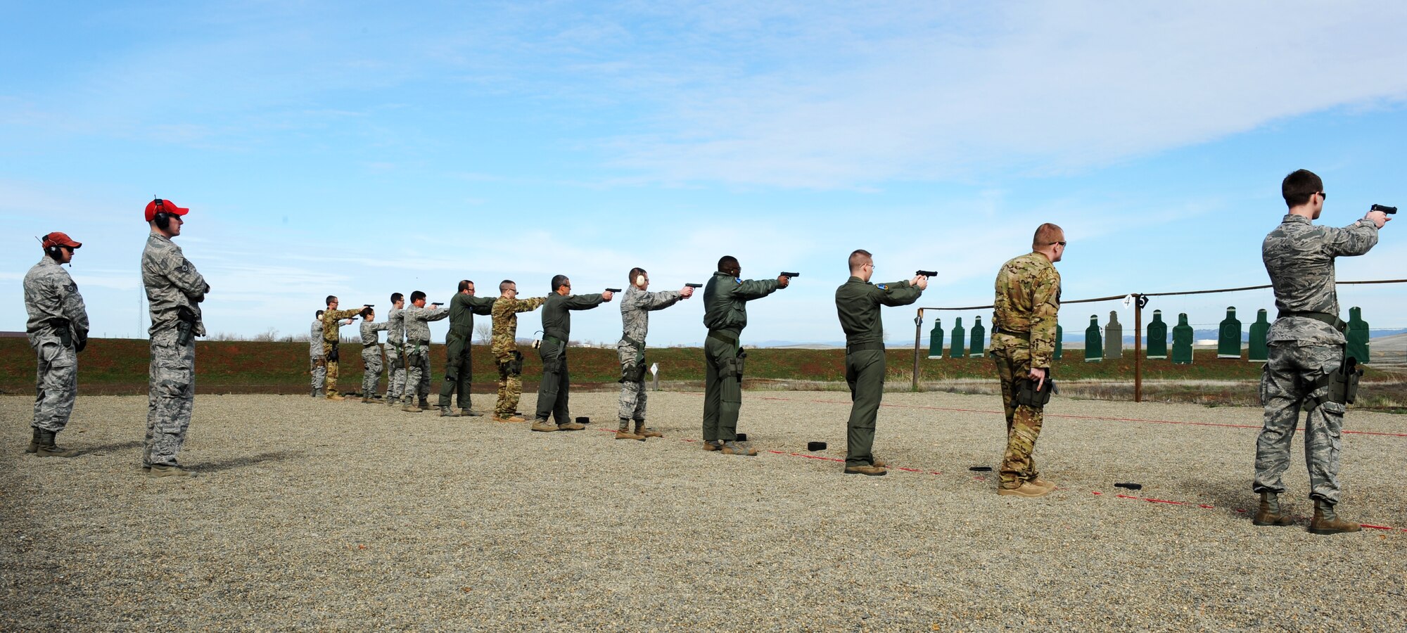 Combat Arms instructors supervise an M-9 weapons qualification course at Beale Air Force Base Calif., Feb. 11, 2014. Students are required to demonstrate marksmanship from distances of seven to 25 meters. (U.S. Air Force photo by Staff Sgt. Robert M. Trujillo/Released)  