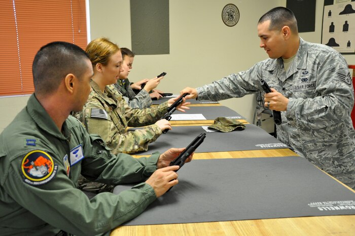 Staff Sgt. Angel Madrigal, 9th Security Forces Squadron combat arms instructor, instructs a M-9 weapons qualification course at Beale Air Force Base, Calif., Feb. 11, 2014. Students are required to demonstrate weapon safety as well as marksmanship. (U.S. Air Force photo by Staff Sgt. Robert M. Trujillo/Released)  