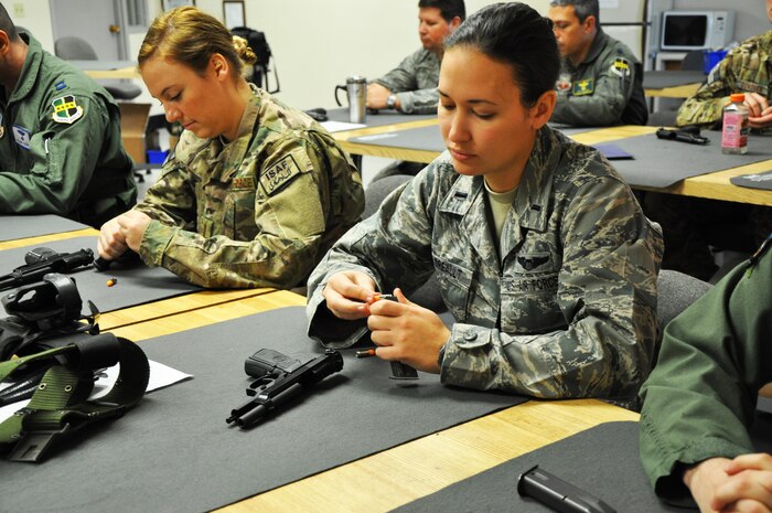 Airmen practice loading and unloading M-9 magazines during a weapons qualification course at Beale Air Force Base, Calif., Feb. 11, 2014. A standard magazine holds 15 rounds of 9mm ammunition.  (U.S. Air Force photo by Staff Sgt. Robert M. Trujillo/Released)  