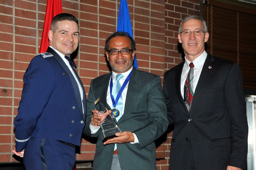 Zak Mohyuddin (center) receives the Annual Engineer of the Year award from AEDC Commander Col. Raymond Toth (left) and ATA Deputy General Manager Phil Stich at the AEDC Annual Award Banquet. (Photos by Jacqueline Cowan)
