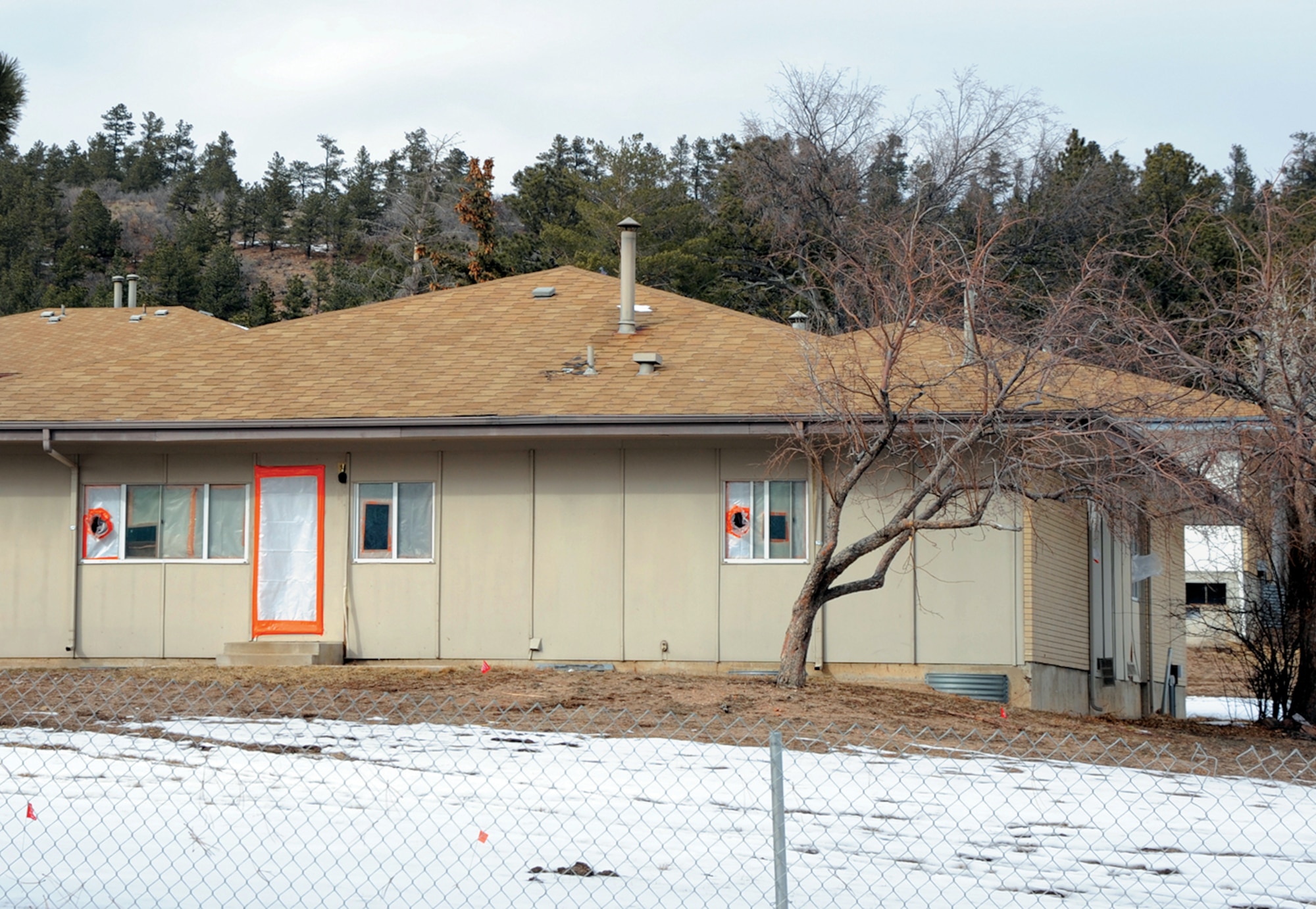A vacant Pine Valley Housing Development home here is boarded-up today. Units in Pine Valley and Douglass Valley in disrepair are scheduled to be demolished and the areas restored to their natural environment. (Air Force photo/Carol Lawrence)