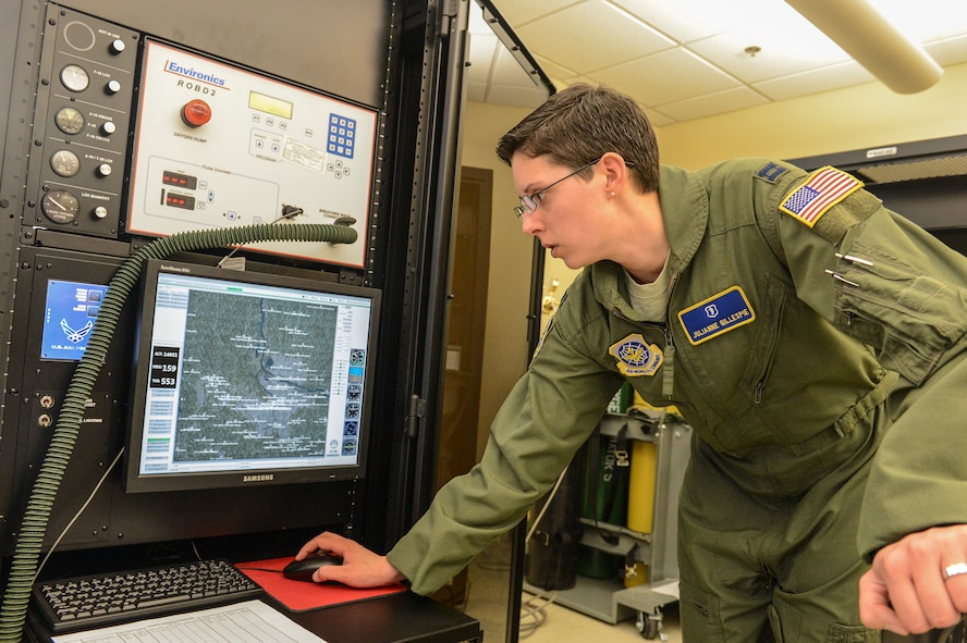 Capt. Julianne Gillespie, 62nd Airlift Wing aerospace and operational physiologist, adjusts the flight simulator map on the Reduced Oxygen Breathing Device at the McChord Field clinic, Feb. 5, 2014 at Joint Base Lewis-McChord, Wash. The ROBD can simulate almost every aircraft in the Air Force fleet and fly over anywhere in the world. (U.S. Air Force photo/Tech. Sgt. Sean Tobin) 