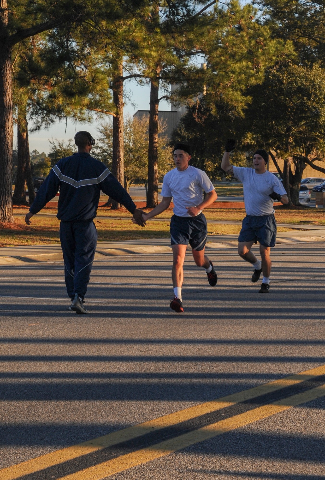 An Airman helps encourage his fellow wingmen as they approach the finish line of a Valentine’s Day 5k at Moody Air Force Base, Ga., Feb. 14, 2014. The course for the run begins at the Freedom I Fitness Center, continues on a trail that leads out to the flightline and back.(U.S. Air Force photo by Airman 1st Class Alexis Millican/Released)