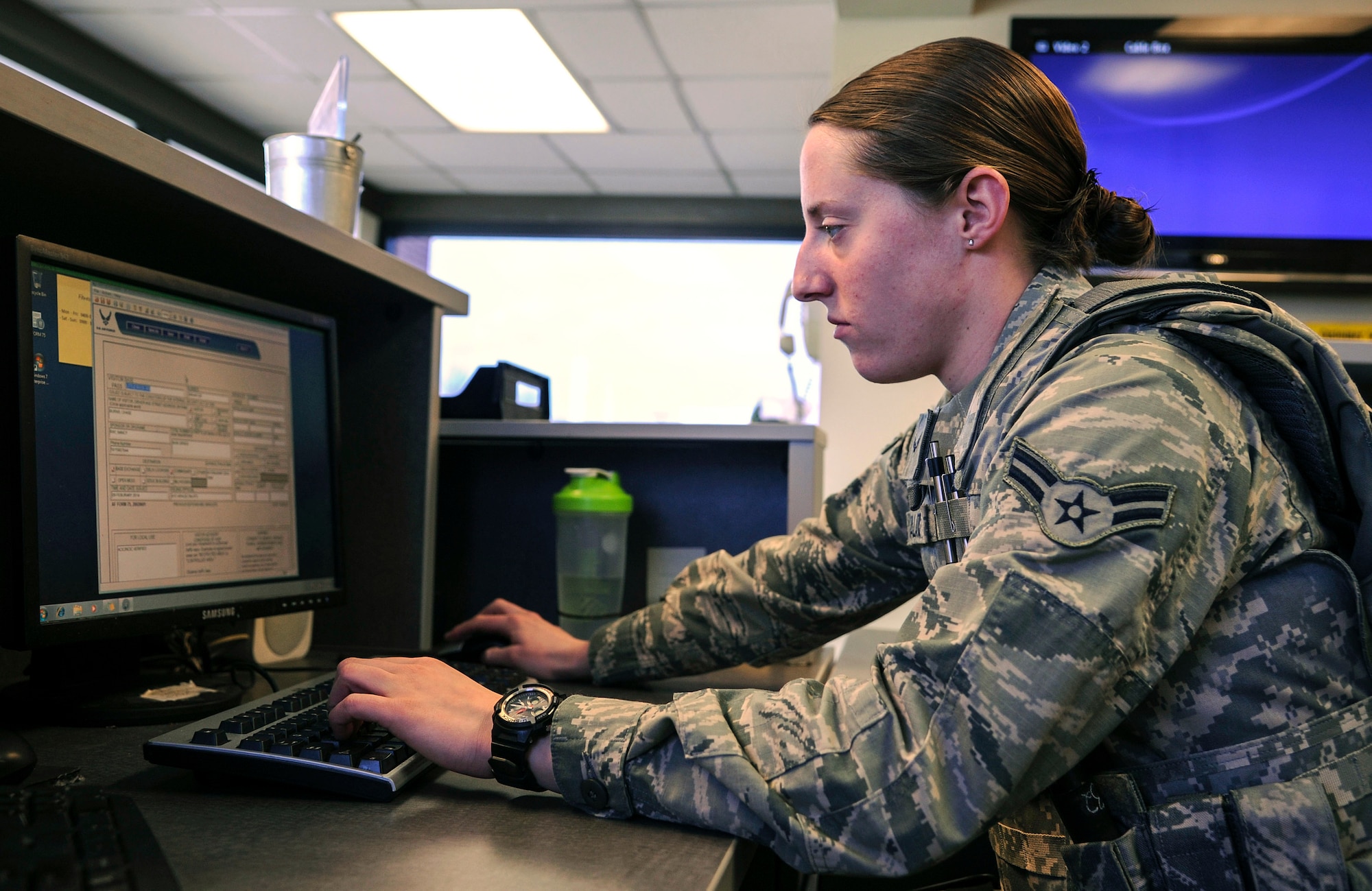 Airman 1st Class Ashlee Salato, a 19th Security Forces Squadron visitor center clerk, fills out a visitor pass Feb. 14, 2014, at Little Rock Air Force Base, Ark. More than 11,000 visitor passes are issued each month. (U.S. Air Force photo by Airman 1st Class Harry Brexel)