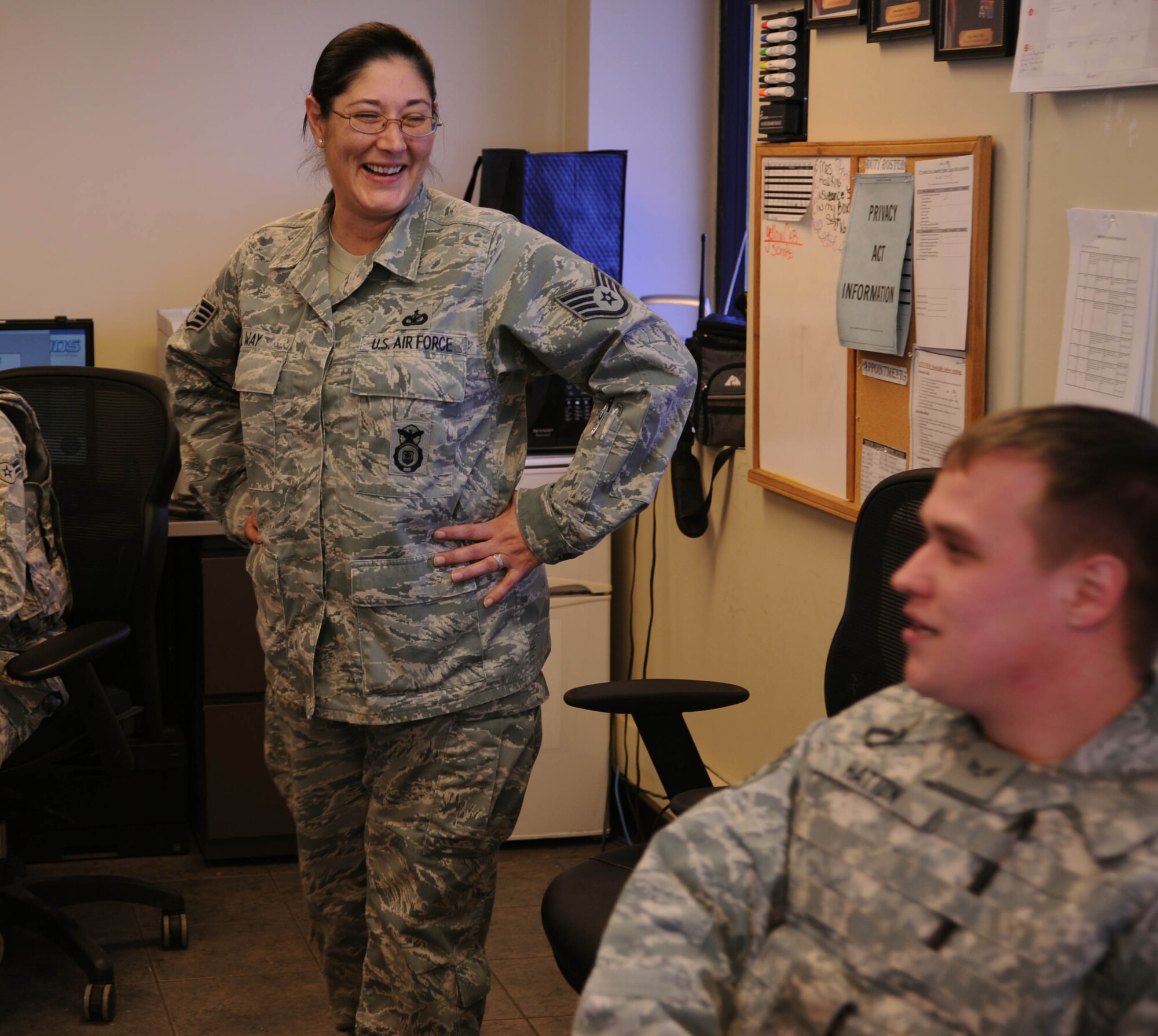 Staff Sgt. Gina Way, 19th Security Forces Squadron noncommissioned officer in charge, laughs as she talks with another SFS Airman Feb, 10, 2014 at Little Rock Air Force Base, Ark. The Little Rock AFB Visitor Center serves as the installation’s first layer of security and ensures that no unauthorized guests gain access to the base. (U.S. Air Force photo by Airman 1st Class Harry Brexel) 
