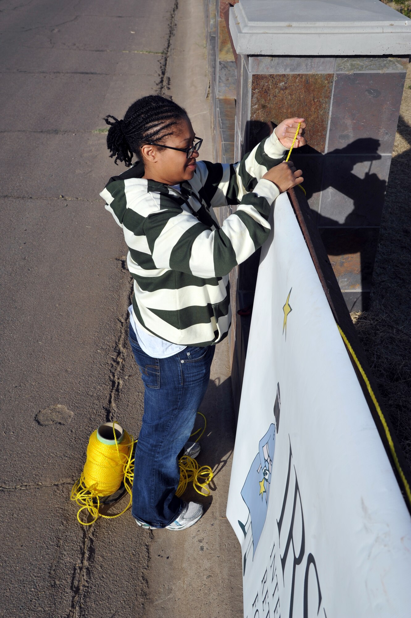 Staff Sgt. Phoeteama Neal, 56th Communication Squadron information assurance technician, hangs banners Feb. 7 for the Heroes of Silent Angels tournament in Phoenix. The event is run by the Society for Creative Anachronisms to raise money for the cure of Rett Syndrome, a form of autism. (U.S. Air Force photo/Senior Airman Jason Colbert)