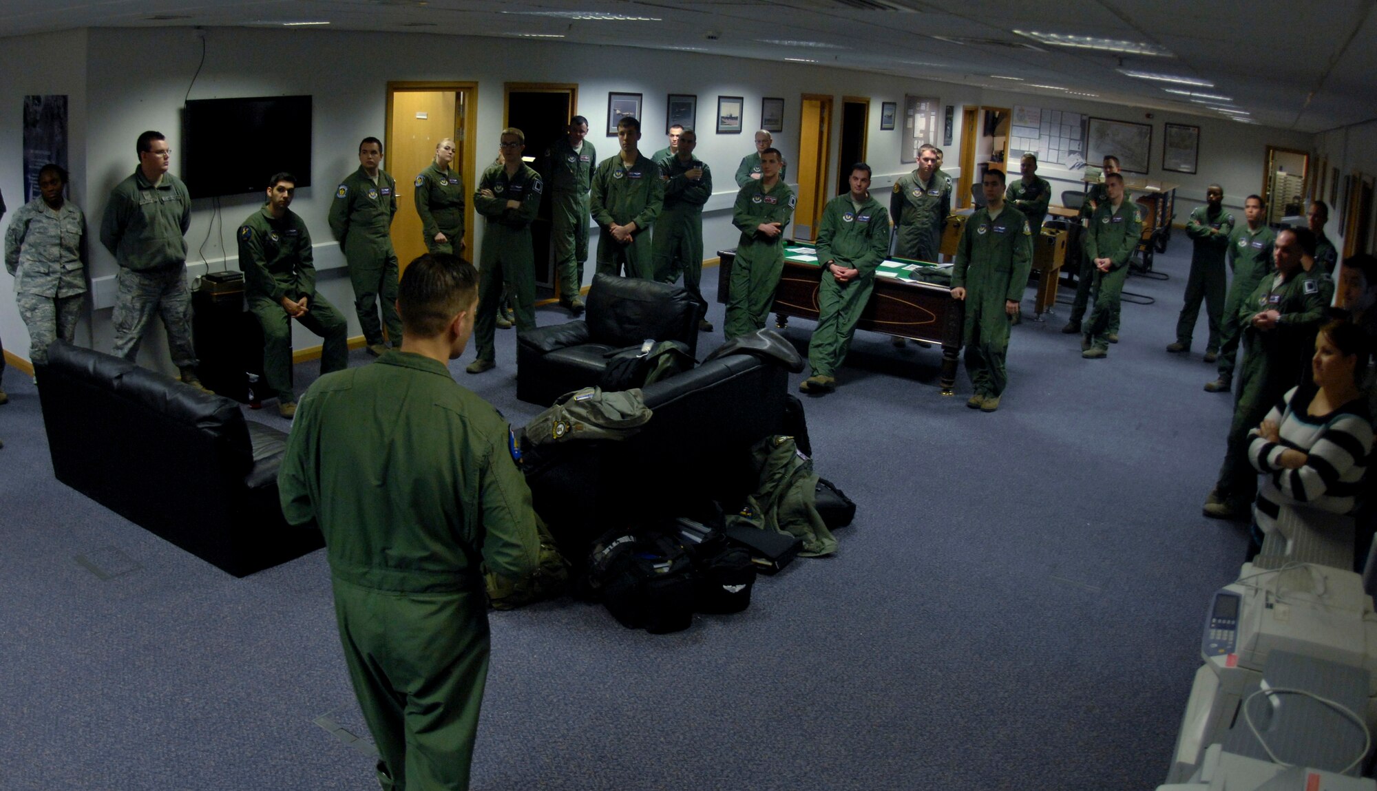 U.S. Air Force Lt. Col. Timothy Kuehne, 351st Air Refueling Squadron commander from Woodbridge, Va., briefs Airmen during roll call Feb. 7, 2014, on RAF Mildenhall, England. Every Friday at 3:51 p.m., Airmen from the 351st ARS gather to remember the heritage of the 351st Bombardment Squadron and recognize newly mission-certified aircrew members in a patching ceremony. After the ceremony, the floor is open for aircrew to discuss the week’s operations and lessons learned. (U.S. Air Force photo by Senior Airman Micaiah Anthony/Released)