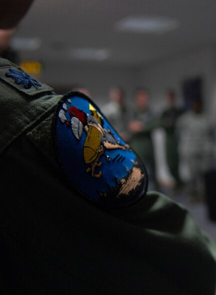 U.S. Air Force Lt. Col. Timothy Kuehne, 351st Air Refueling Squadron commander from Woodbridge, Va., wears a 351st Bomb Squadron patch during roll call Feb. 7, 2014, on RAF Mildenhall, England. Mission-certified 351st ARS Airmen wear the patch on Fridays in remembrance of the 351st BS and its role during World War II. (U.S. Air Force photo by Senior Airman Micaiah Anthony/Released)