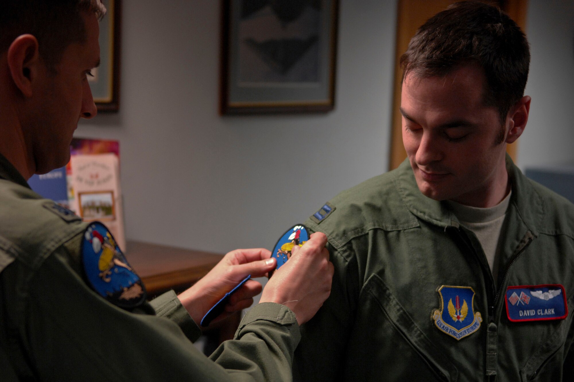U.S. Air Force Lt. Col. Timothy Kuehne, left, 351st Air Refueling Squadron commander from Woodbridge, Va., tacks on a 351st Bombardment Squadron patch to U.S. Air Force Capt. David Clark’s, 351st ARS wing weapons and tactics officer from St. Claire Shores, Mich., uniform during roll call Feb. 7, 2014, on RAF Mildenhall, England. New aircrew members receive the patch after completing their mission-certification training. Officers and Enlisted Airmen in the unit wear the patch, which can take anywhere from one week to 45 days to earn. (U.S. Air Force photo by Senior Airman Micaiah Anthony/Released)
