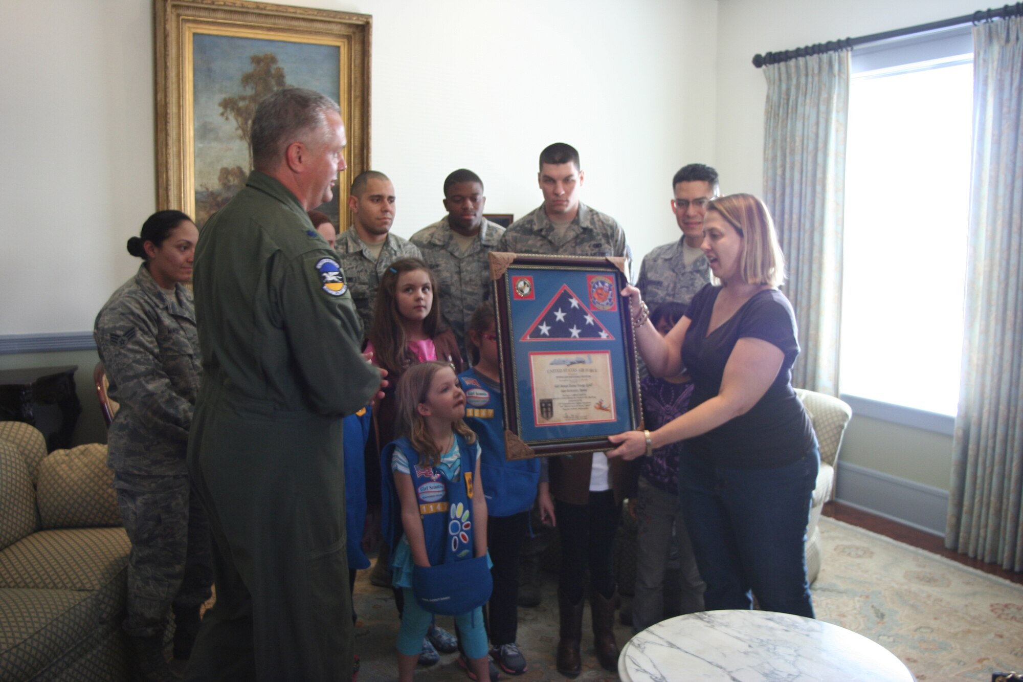 Col. Jimmie Brooks, 356th Airlift Squadron, commander (433rd Airlift Wing) presents an American Flag to Troop Leader Christine Wilson of the Girl Scouts of Southwest Texas, Troop 1147 for their support while deployed in support of Operation Enduring Freedom, Feb. 9, 2014. The flag was flown over Afghanistan, while the Airmen were deployed in support of Operation Enduring Freedom. The presentation was held at the Sally Cheever Girl Scout Leadership Center in San Antonio.

