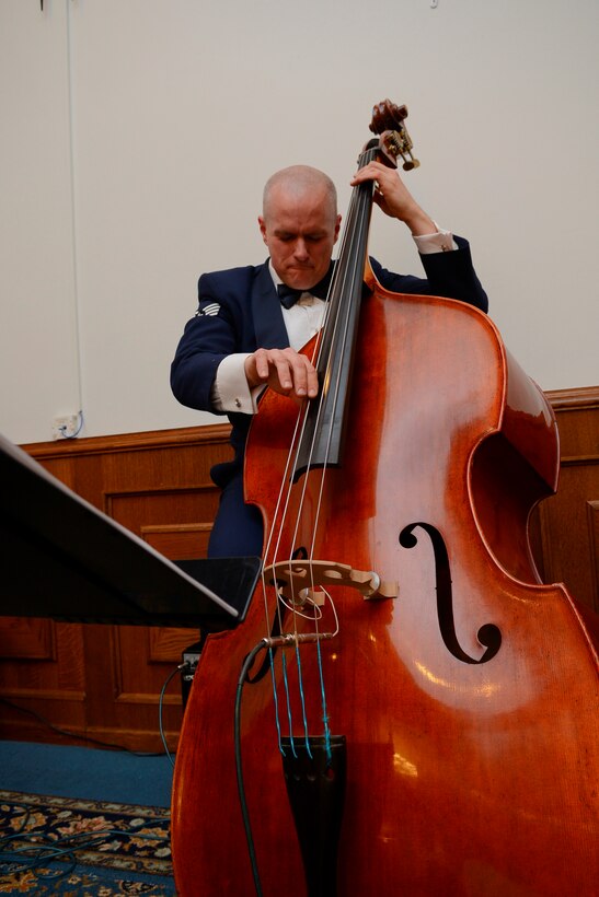 Staff Sergeant Joe Whitt digs into a bass solo during the annual KMC Chief Master Sergeant Recognition Ceremony.  The Ambassadors Jazz Combo  provide entertainment for official military events throughout Germany and the European Theater.  (U.S. Air Force photo by Senior Airman Jose L. Leon/Released)