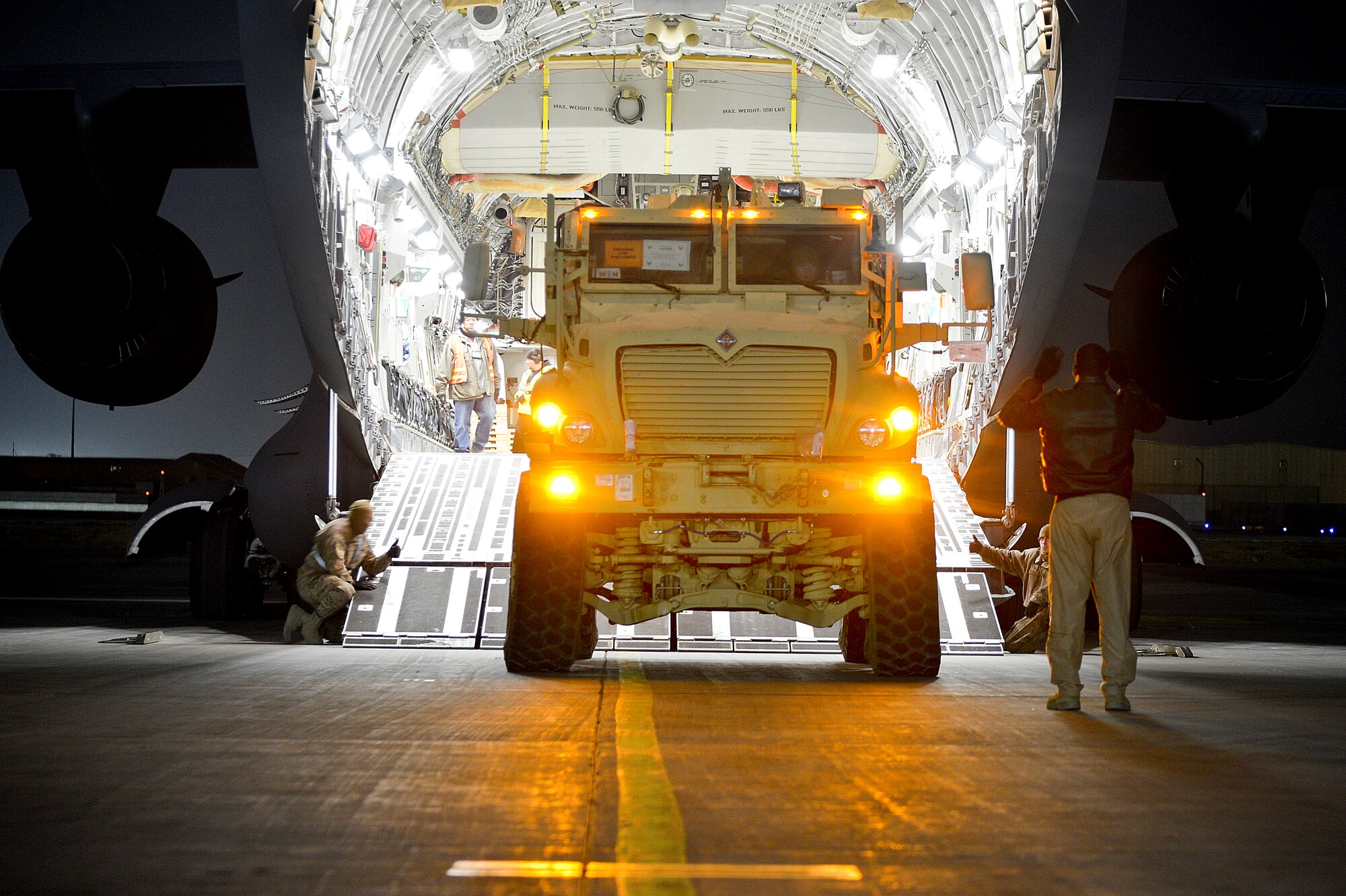 A mine-resistant ambush-protected vehicle is loaded onto a C-17 Globemaster III at Bagram Airfield, Afghanistan, Feb. 13, 2014. Along with the MRAP, two other tactical vehicles were loaded onto the C-17. (U.S. Air Force photo by Senior Airman Kayla Newman/Released)