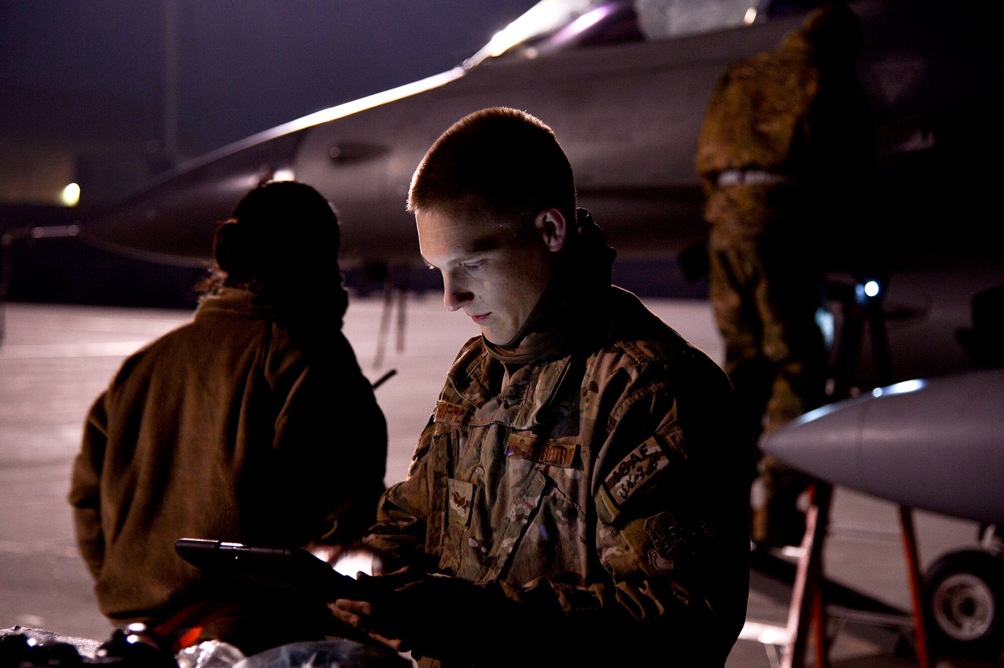U.S. Air Force Senior Airman Stephen Hoffler, 455th Expeditionary Aircraft Maintenance Squadron weapons load crew member, uses maintenance technology to assist in fixing an F-16 Fighting Falcon at Bagram Airfield, Afghanistan, Feb. 13, 2014. Hoffler is deployed from Homestead Air Reserve Base, Fla., and a native of Fayetteville, Ga. (U.S. Air Force photo by Senior Airman Kayla Newman/Released)