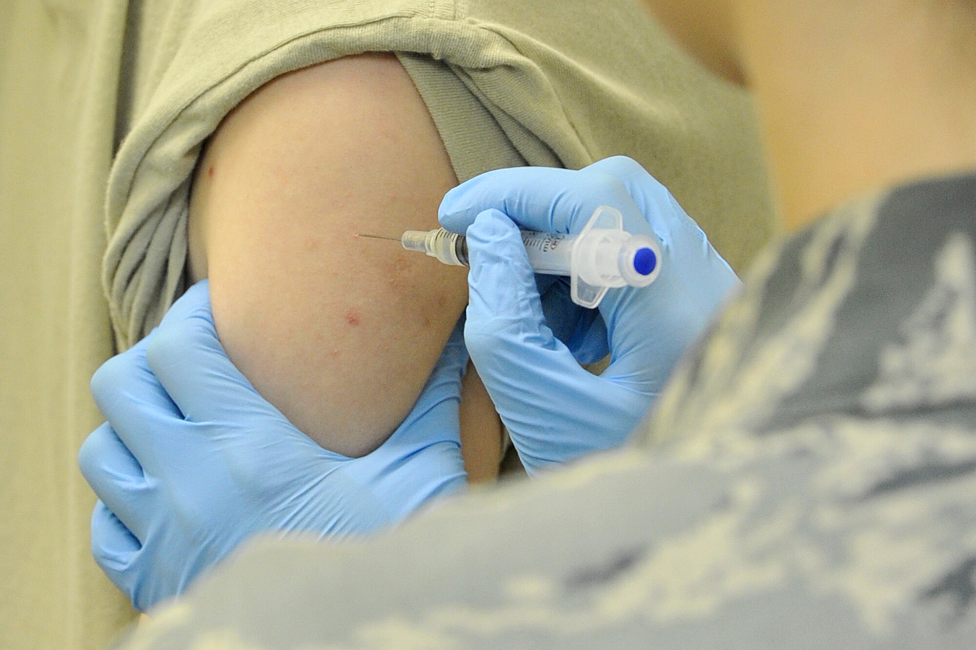 MISAWA AIR BASE, Japan – Staff Sgt. Teryn Granger, 35th Medical Operations Squadron aerospace medicine technician, prepares to inject influenza vaccine in a patient at Misawa Air Base, Japan, Feb. 10, 2014. The 35th Medical Group immunization clinic sees an average of 10 people a day for vaccinations. (U.S. Air Force photo/Staff Sgt. Tong Duong)