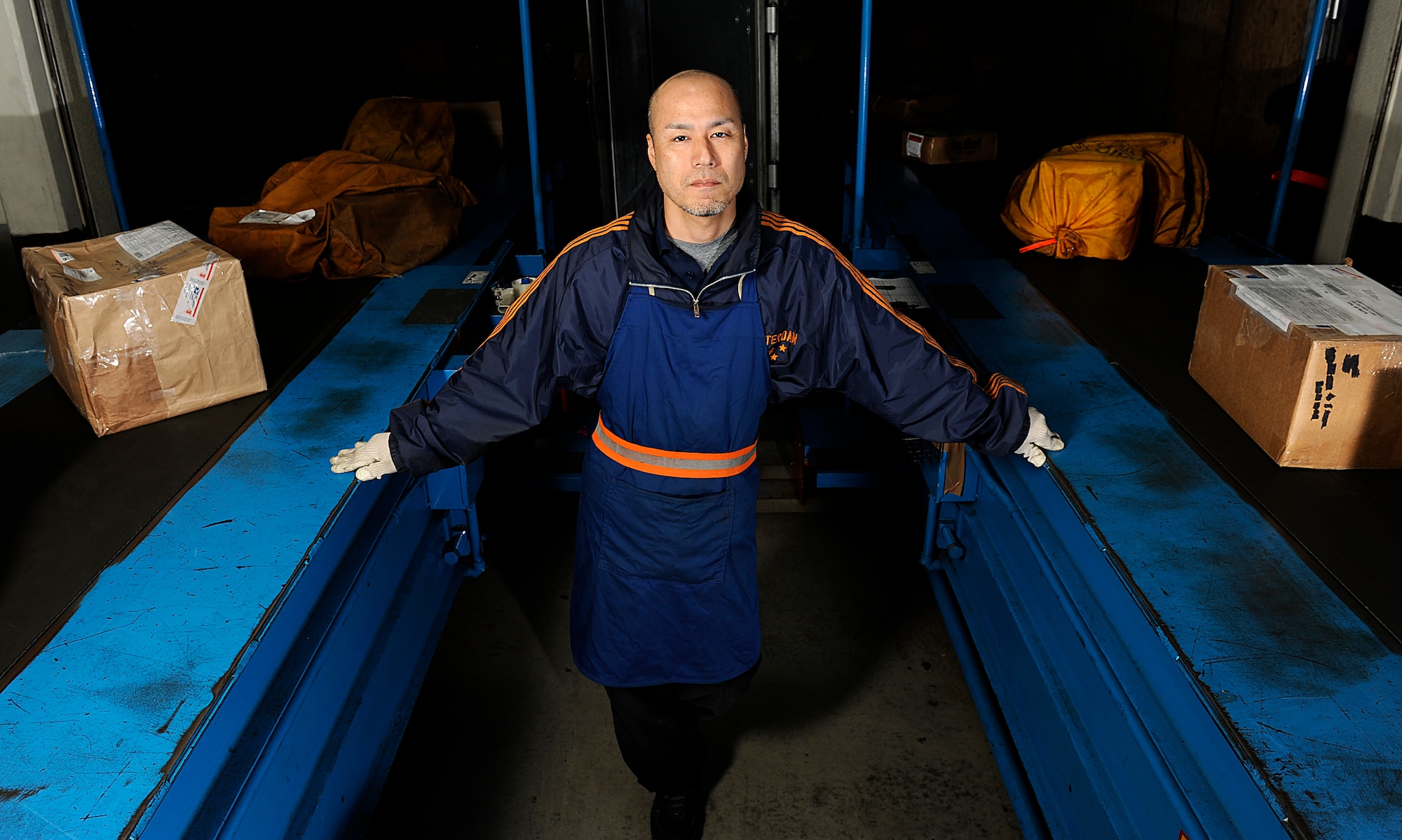 Yukata Hokama, Detachment 3 Pacific Air Forces Air Postal Squadron postal specialist, poses at the detachment on Naha Air Base, Japan, Feb. 13, 2014. Hokama, who's been working at the detachment for more than 13 years, recently won the 2013 Air Force Information Dominance Outstanding Civilian Assistant award for his hard work from Oct. 1, 2012, to Sept. 30, 2013. (U.S. Air Force photo by Senior Airman Maeson L. Elleman)