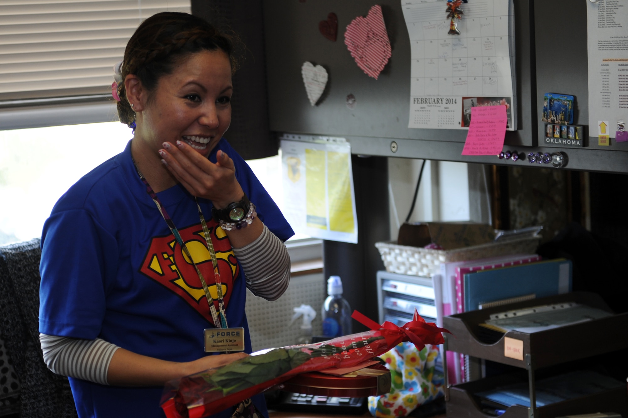 Kaori Kinjo, 18th Force Support Squadron management assistant, receives a Valentine’s Day gift set delivered by Kadena Top Three on Kadena Air Base, Japan, Feb. 14, 2014.  More than 100 gift sets, which included three roses, a box of chocolates and a personalized note, were delivered to five military installations on Okinawa. (U.S. Air Force photo by Airman 1st Class Zade C. Vadnais)
