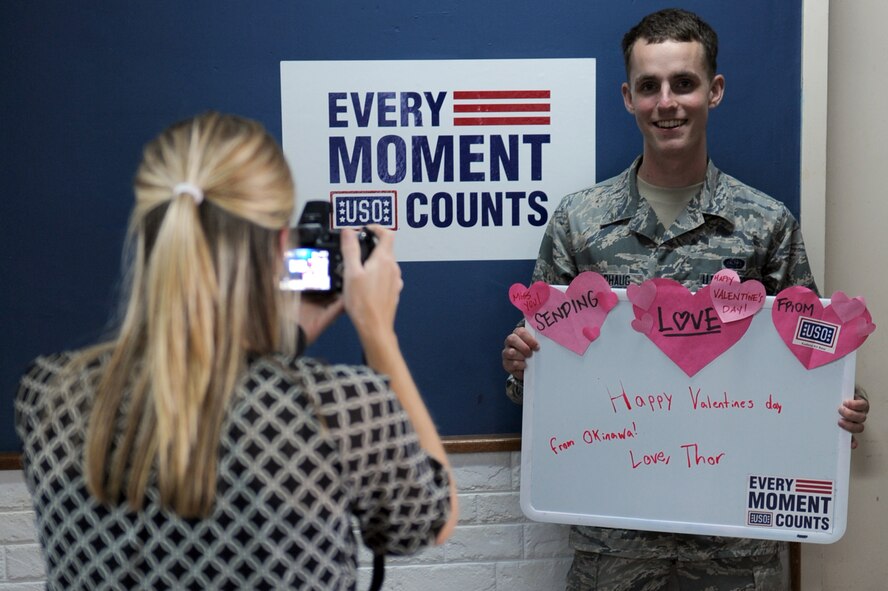 U.S. Air Force Airman 1st Class Adam Thorhaug, 353rd Special Operations Support Squadron client systems administrator, poses for a photo holding a whiteboard with a special Valentine’s Day message
on Kadena Air Base, Japan, Feb. 13, 2014.  The photo was taken as part of the USO’s “Every Moment Counts” Valentine’s Day campaign, which allows airmen and their families to send special messages to their geographically-separated loved ones. (U.S. Air Force photo by Airman 1st Class Zade C. Vadnais)
