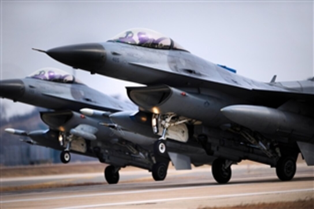 Two F-16 Fighting Falcons land in sync after a training sortie at Kunsan Air Base, Korea, Feb. 13, 2014. The pilots are assigned to the 35th Fighter Squadron. 