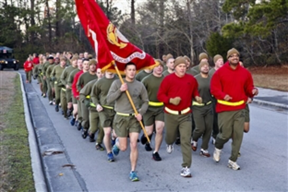Navy Capt. Michael A. Sokolowski, center, leads the battalion in the cardiac run on Camp Lejeune, N.C., Feb. 14, 2014. Marines and sailors ran about three miles to support a healthier lifestyle and Valentine's Day. Sokolowski is the commanding officer of 2nd Medical Battalion, Combat Logistics Regiment 25, 2nd Marine Logistics Group