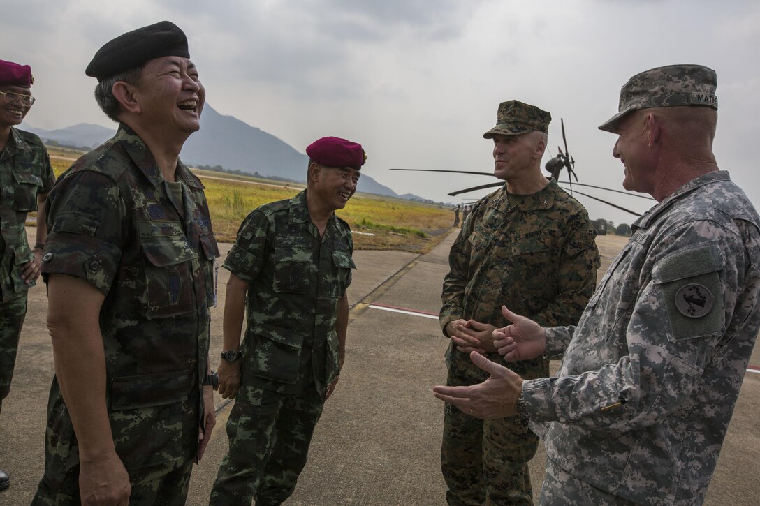 From the left, Royal Thai Lt. Gen. Chalermchai Sitthisad, Maj. Gen. Wittaya Wachirakul,, U.S. Marine Corps Brig. Gen. Richard Simcock, and U.S. Army Maj. Gen. Roger A. Mathews, laugh during a conversation
while watching a combined strategic air drop demonstration during Exercise Cobra Gold 2014 in Lop Buri, Kingdom of Thailand Feb. 15. Cobra Gold, in its 33rd iteration, demonstrates the U.S. and the Kingdom of Thailand's commitment to our long-standing alliance and regional partnership, prosperity and security in the Asia-Pacific region. The aerial insertion of over 400 combined troops belonging to the Royal Thai and U.S. Armed Forces was held in order to demonstrate forcible entry capabilities. Sitthisad is the commanding general, Special Warfare Command. Wattaya is the command of Royal Thai J7.
Mathews is the commanding general of U.S. Army Pacific. Simcock is the deputy commanding general of U.S. Marine Corps Forces Pacific.