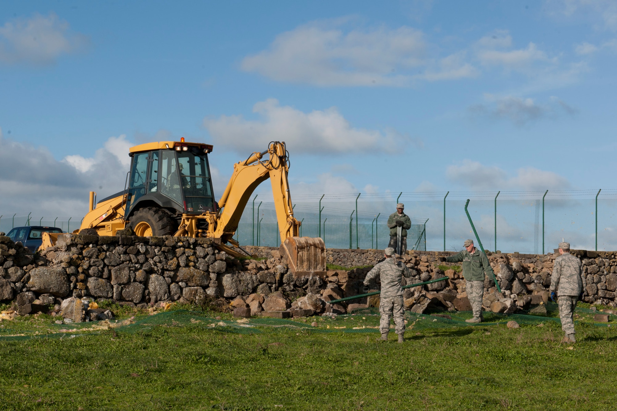 U.S. Air Force Airmen from the 65th Civil Engineer Squadron remove portions of a broken fence Feb. 15, 2014, at Lajes Field, Azores. Lajes Field was hit with a low pressure weather system Feb. 13, and strong winds caused damages to base facilities and military family housing. (U.S. Air Force photo by Tech. Sgt. Paul Villanueva II/Released)
