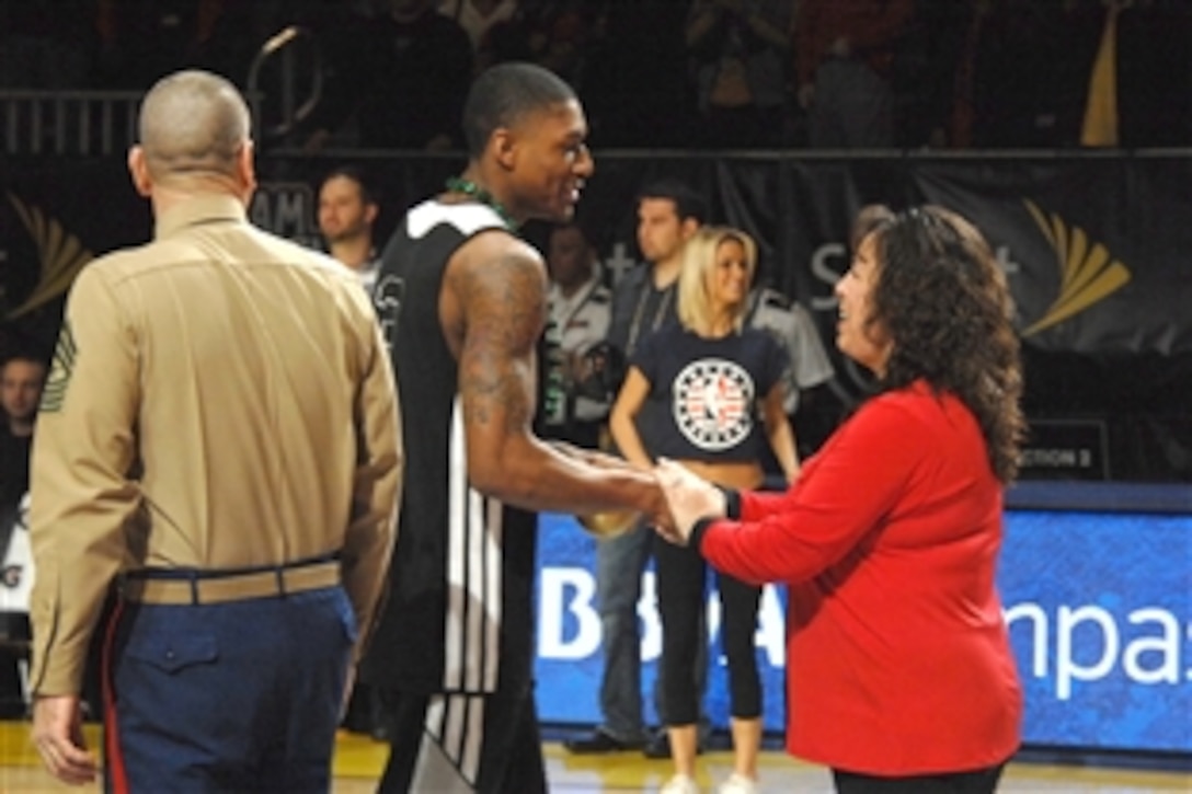 Marine Corps Sgt. Maj. Bryan B. Battaglia, senior enlisted advisor to the Chairman of the Joint Chiefs of Staff, and his wife, Lisa, greet athletes during the NBA Rising Stars Practice at the Ernest N. Morial Convention Center in New Orleans, Feb. 14, 2014. More than 2,500 service members, veterans and their families were guests at the closed practice, which is part of the pre-game activities at the NBA All-Star Game.