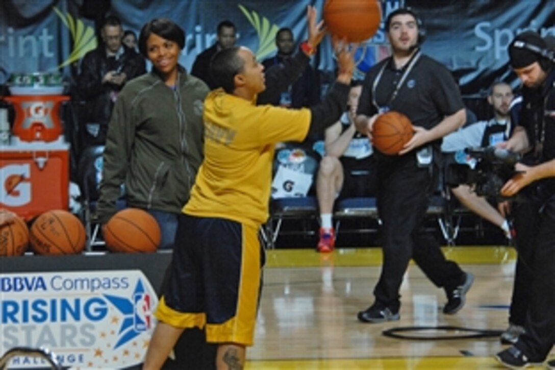 Participants shoot hoops during the NBA Rising Stars Practice at the Ernest N. Morial Convention Center in New Orleans, Feb. 14, 2014. More than 2,500 service members, veterans and their families attended the closed practice as past of the pre-game activities at the NBA All-Star Game.