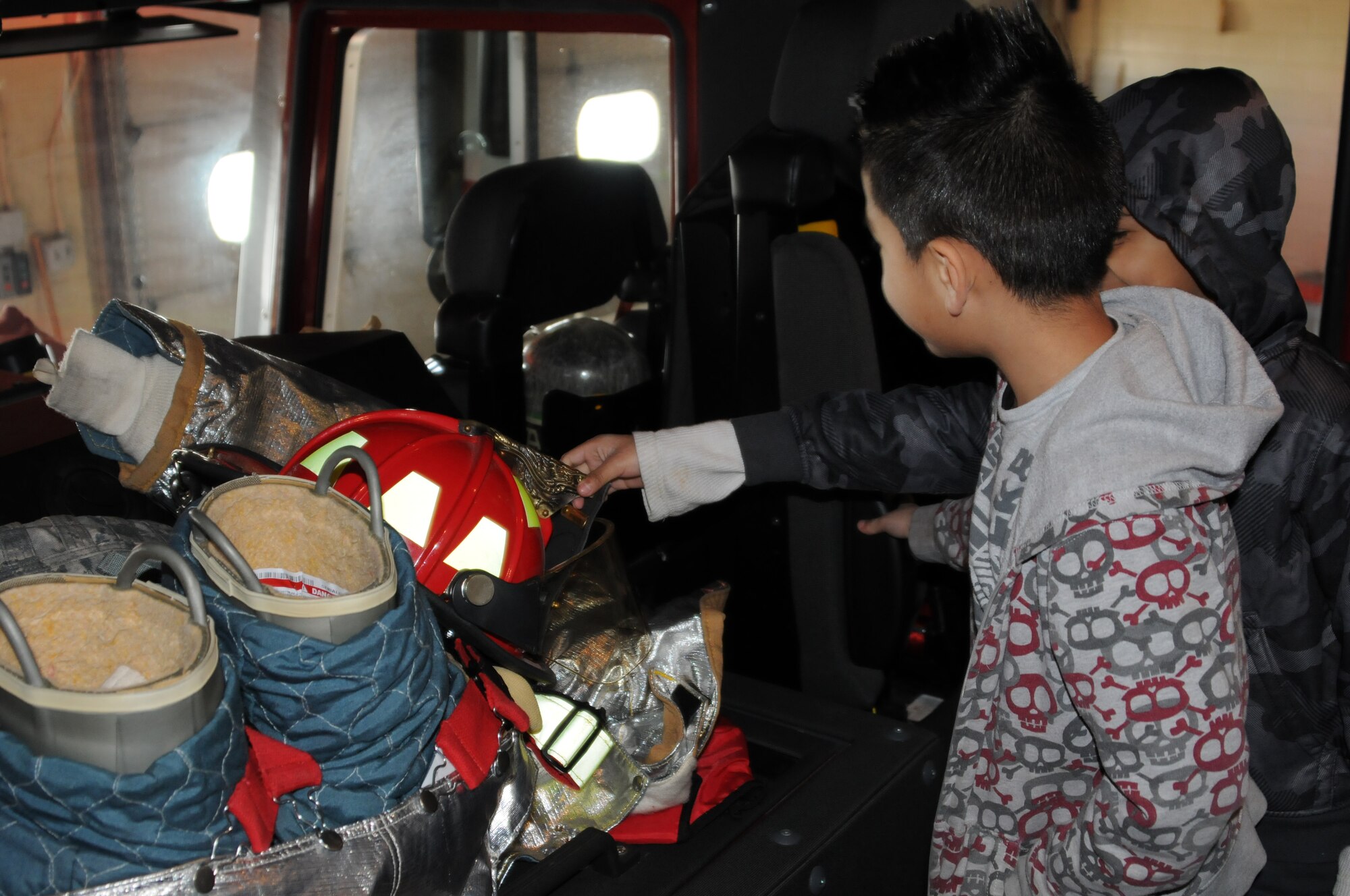 Students with Fort Smith (Ark.) Sutton Elementary School view protective equipment from the inside of a fire truck at the 188th Fighter Wing’s Ebbing Air National Guard Base fire station, Jan. 29, 2014. Sutton toured the 188th as part of the Fort Smith School District’s Partners in Education program. The 188th has been Sutton’s partner for more than 20 years. Sutton toured the 188th’s hangar, fire station and Security Forces Squadron during its visit. The group also had lunch in the 188th’s Citizen Airmen Dining Hall. (U.S. Air National Guard photo by Maj. Heath Allen)
