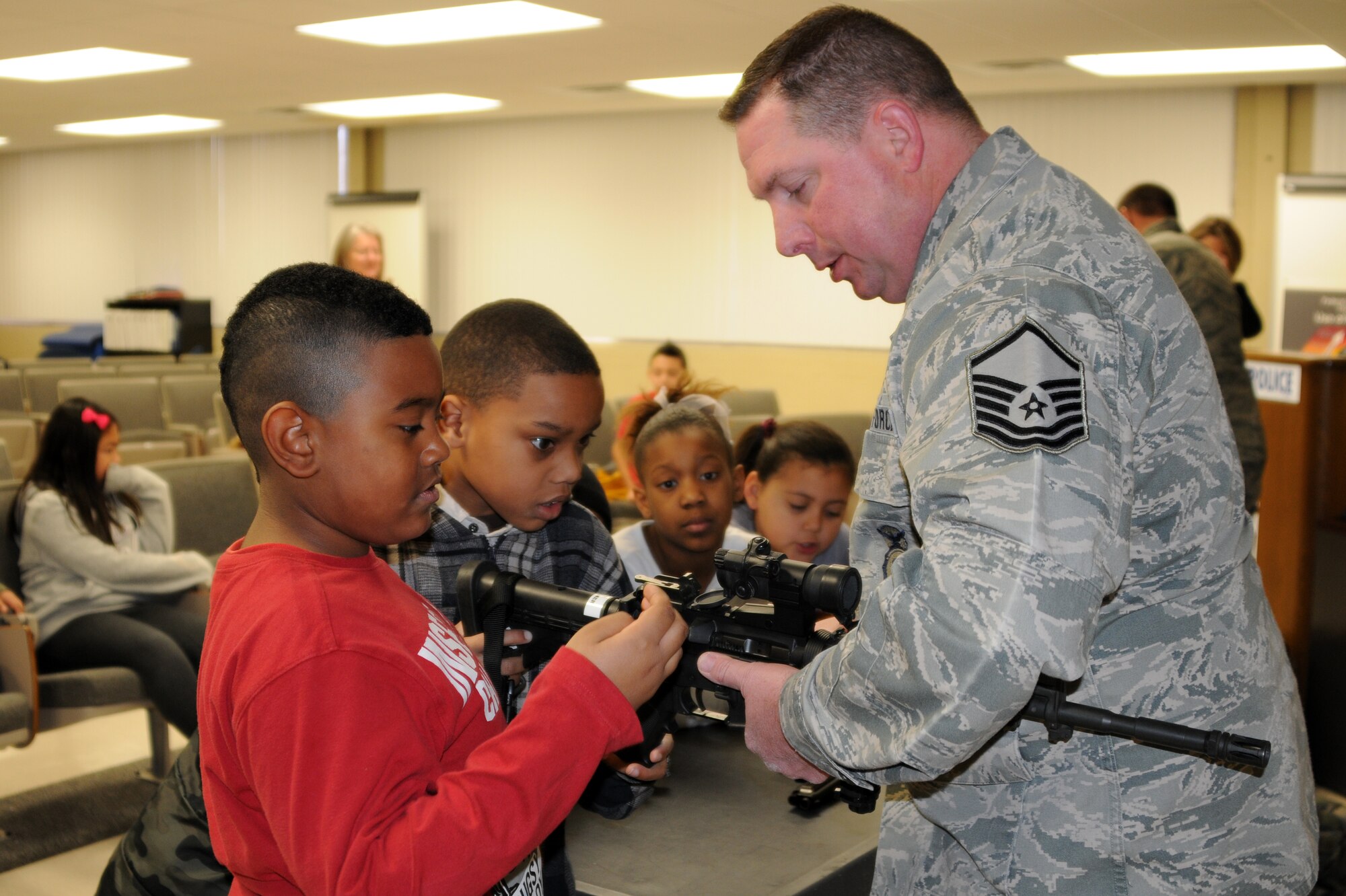 Master Sgt. Greg Palmer, 188th Security Forces Squadron, shows the M-4 rifle to students with Fort Smith (Ark.) Sutton Elementary School. Sutton toured the 188th Fighter Wing’s Ebbing Air National Guard Base Jan. 29, 2014, as part of the Fort Smith School District’s Partners in Education program. The 188th has been Sutton’s partner for more than 20 years. Sutton toured the 188th’s hangar, fire station and Security Forces Squadron during its visit. The group also had lunch in the 188th’s Citizen Airmen Dining Hall. (U.S. Air National Guard photo by Maj. Heath Allen)