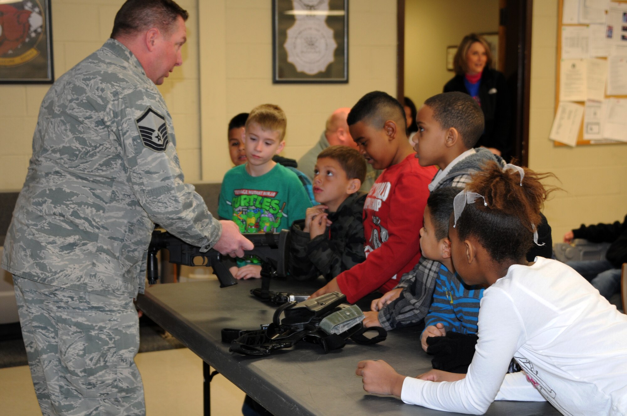 Master Sgt. Greg Palmer, 188th Security Forces Squadron, shows the M-4 rifle to students with Fort Smith (Ark.) Sutton Elementary School. Sutton toured the 188th Fighter Wing’s Ebbing Air National Guard Base Jan. 29, 2014, as part of the Fort Smith School District’s Partners in Education program. The 188th has been Sutton’s partner for more than 20 years. Sutton toured the 188th’s hangar, fire station and Security Forces Squadron during its visit. The group also had lunch in the 188th’s Citizen Airmen Dining Hall. (U.S. Air National Guard photo by Maj. Heath Allen)