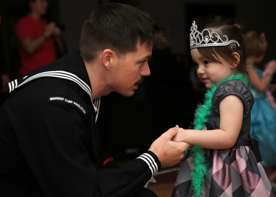 Petty Officer 3rd Class Jeremiah Watson, line corpsman, B co., 3rd Combat Engineer Battalion, asks his daughter Angelina Watson, 3 years old, to dance while on a knee during the "Princess of the Castle" event Feb. 7, 2014 held at the Officers' Club. Angelina did not want to dance until her father went to a knee and asked her cordially.


