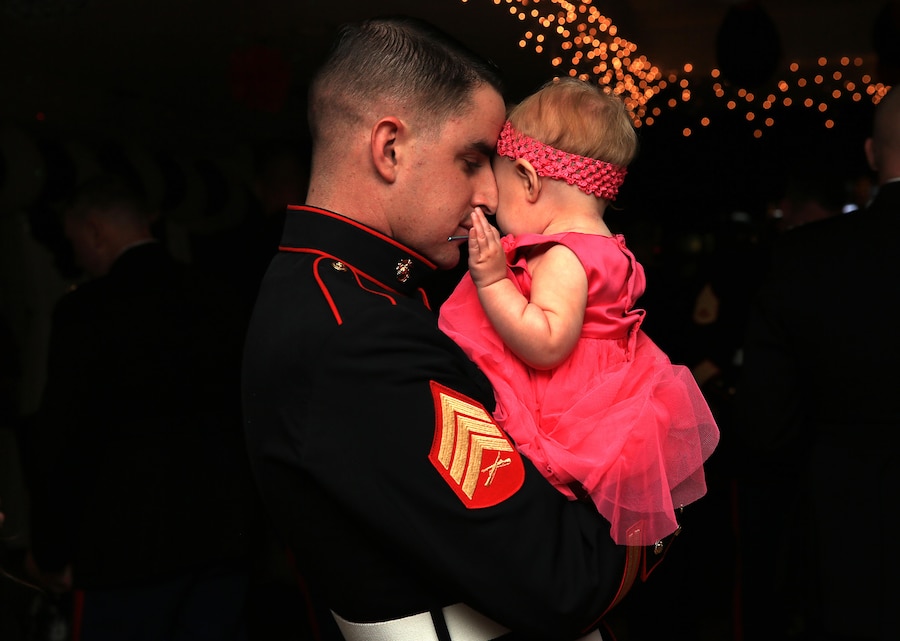 Sgt. Juan Ramos, heavy equipment mechanic, 3rd Combat Engineer Battalion, shares an embrace with his daughter, Zuly Ramos, 8 months old, during a slow song at the "Princess of the Castle" event Feb. 7, 2014, hosted at the Officers' Club. This event is the first of its kind for 3rd Combat Engineer Battalion.