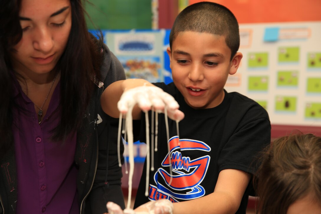 Erika Barbagallo, 13, and Joseph Barbagallo Jr., 10, son and daughter of Gunnery Sgt. Joseph Barbagallo, maintenance chief, 3rd Light Armored Reconnaissance Battalion, experiment in the Obleck Station during Condor Elementary's Science Night Feb. 5, 2014. When pressure is applied to 'Obleck,' it is solid but when no pressure is applied, the substance turns into a liquid.


